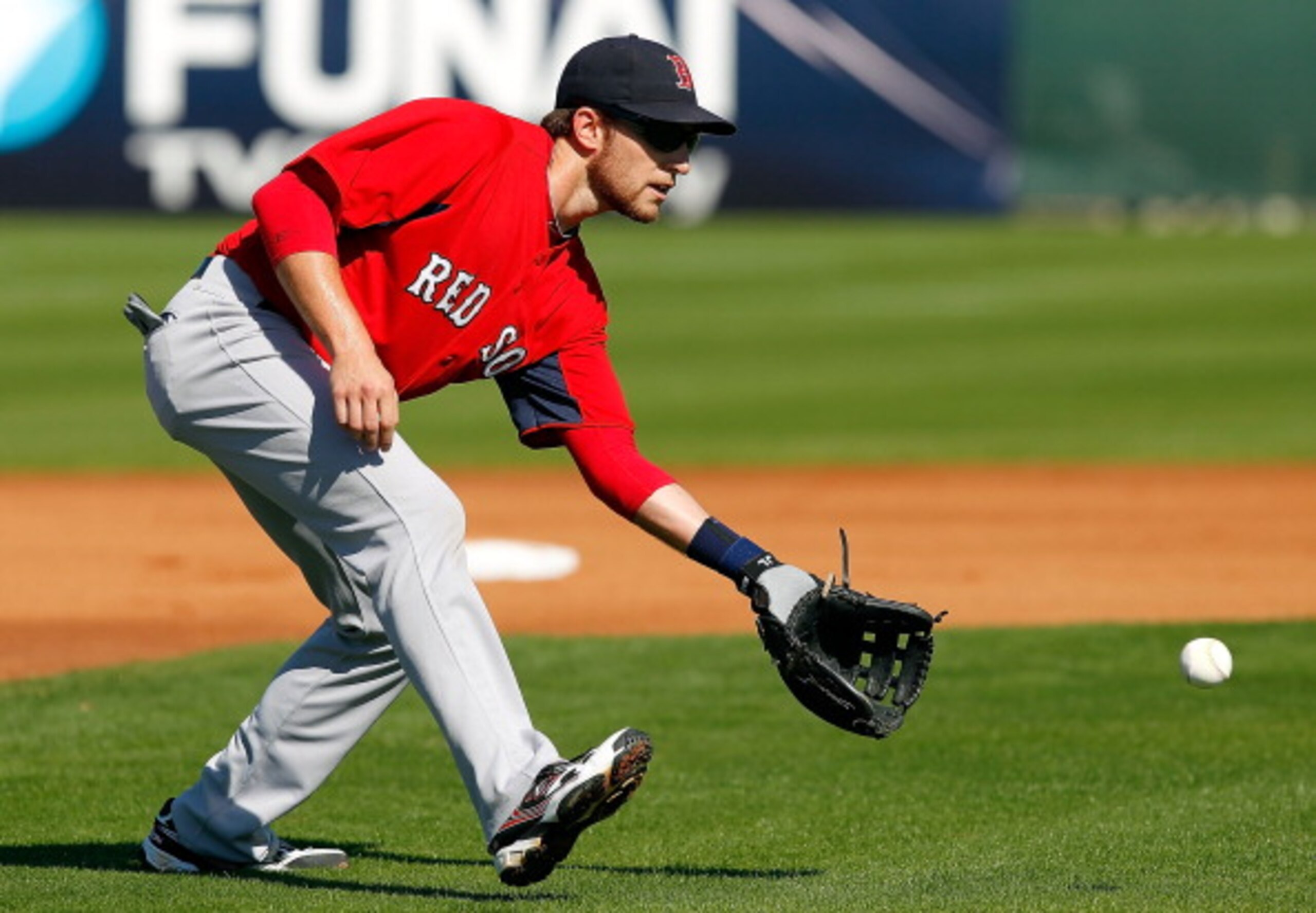FORT MYERS, FL - FEBRUARY 19: Infielder Jed Lowrie #12 of the Boston Red Sox fields a ground ball during a Spring Training Workout Session at the Red Sox Player Development Complex on February 19, 2011 in Fort Myers, Florida. (Photo by J. Meric/Getty Im FORT MYERS, FL - FEBRUARY 19: Infielder Jed Lowrie #12 of the Boston Red Sox fields a ground ball during a Spring Training Workout Session at the Red Sox Player Development Complex on February 19, 2011 in Fort Myers, Florida. (Photo by J. Meric/Getty Im