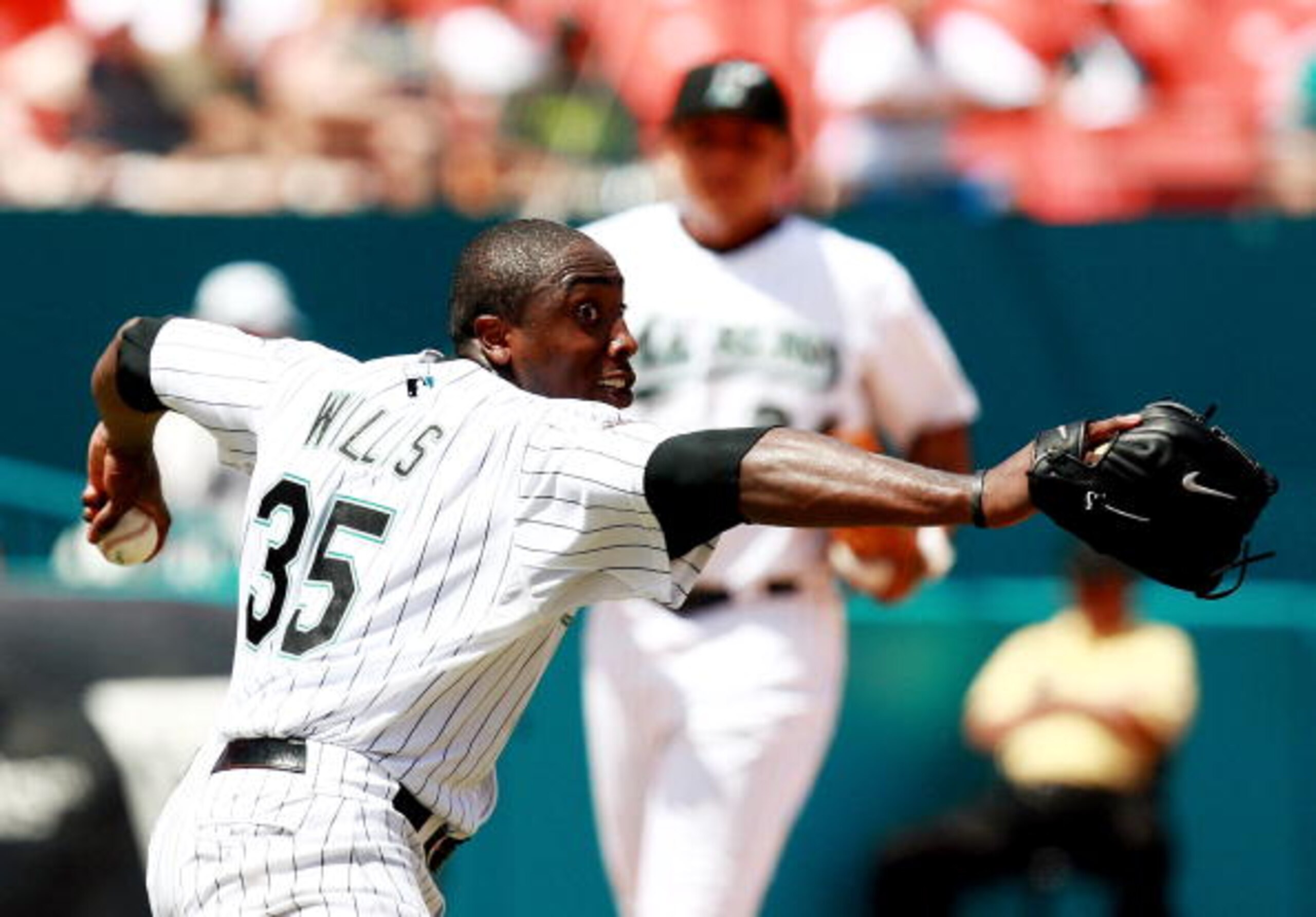 MIAMI - AUGUST 19:  Dontrelle Willis #35 of the Florida Marlins throws to first after knocking down a line drive by Rich Aurilia of the San Francisco Giants in the sixth inning at Dolphin Stadium on August 19, 2007 in Miami, Florida.  (Photo by Doug Benc/