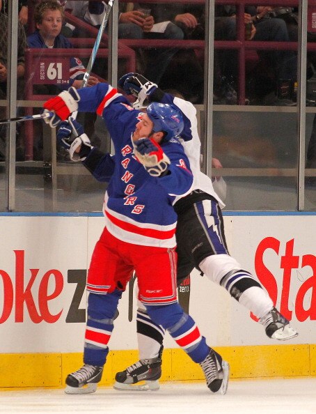 NEW YORK, NY - DECEMBER 23:  Brandon Prust #8 of the New York Rangers checks Sean Bergenheim #10 of the Tampa Bay Lightning during the second period of an NHL hockey game at Madison Square Garden on December 23, 2010 in New York City.  (Photo by Paul Bere
