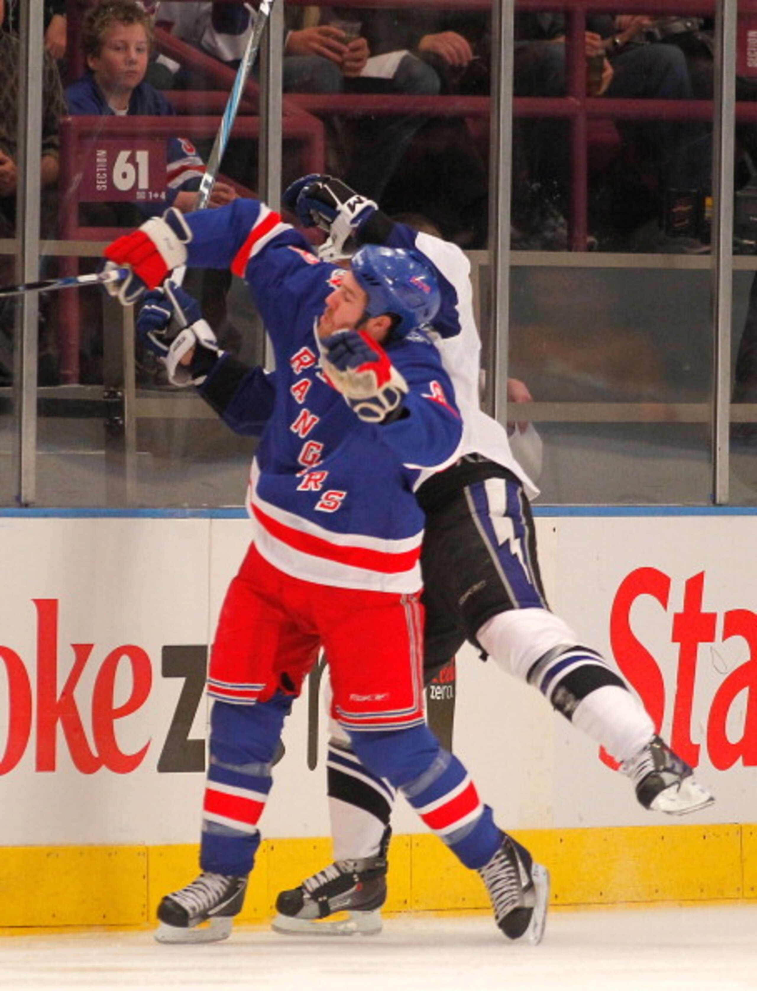 NEW YORK, NY - DECEMBER 23:  Brandon Prust #8 of the New York Rangers checks Sean Bergenheim #10 of the Tampa Bay Lightning during the second period of an NHL hockey game at Madison Square Garden on December 23, 2010 in New York City.  (Photo by Paul Bere