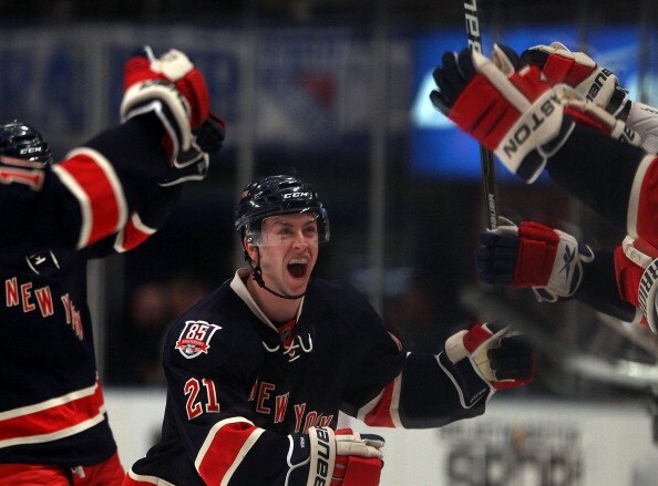 NEW YORK, NY - APRIL 04:  Derek Stepan #21 of the New York Rangers scores an empty net goal at 19:07 of the third period against the Boston Bruins at Madison Square Garden on April 4, 2011 in New York City.The Rangers defeated the Bruins 5-3.  (Photo by B