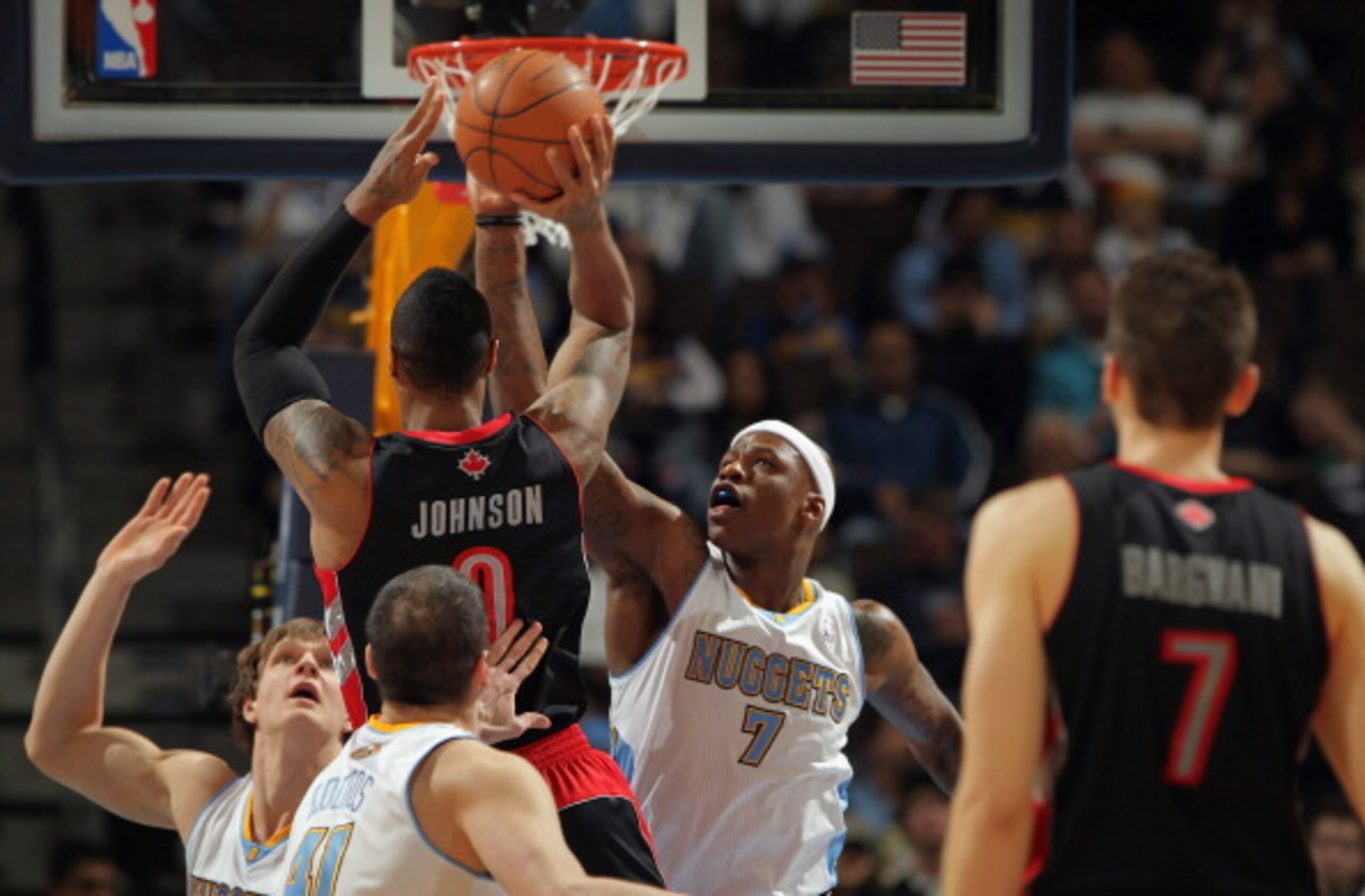 DENVER, CO - MARCH 21: Al Harrington #7 of the Denver Nuggets looks to block a shot by James Johnson #0 of the Toronto Raptors at the Pepsi Center on March 21, 2011 in Denver, Colorado. The Nuggets defeated the Raptors 123-90. NOTE TO USER: User expressl DENVER, CO - MARCH 21: Al Harrington #7 of the Denver Nuggets looks to block a shot by James Johnson #0 of the Toronto Raptors at the Pepsi Center on March 21, 2011 in Denver, Colorado. The Nuggets defeated the Raptors 123-90. NOTE TO USER: User expressl