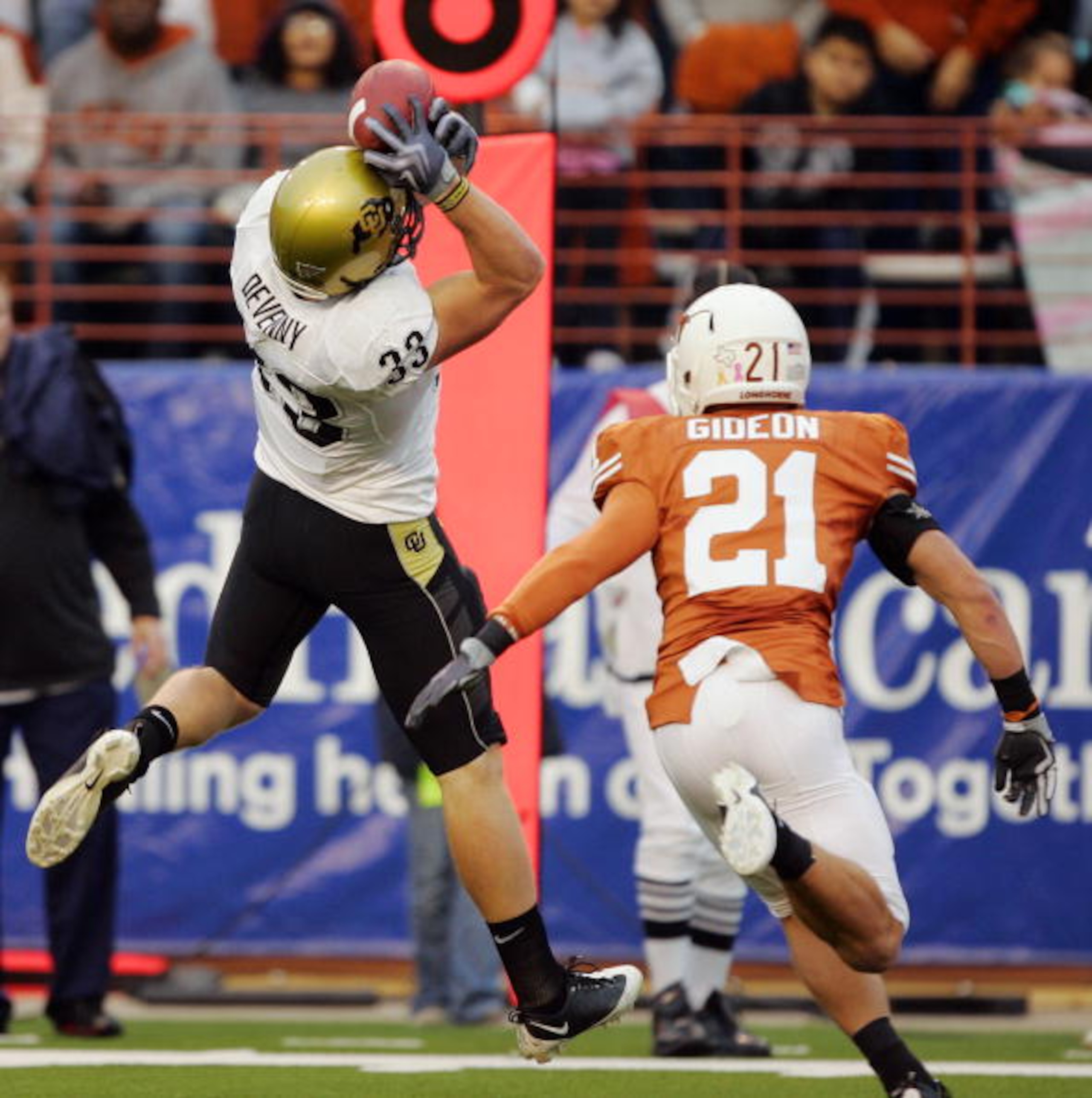 AUSTIN, TX - OCTOBER 10: Tight end Patrick Devenny #33 of the Colorado Buffaloes catches a pass on the top of his helmet for a touchdown against safety Blake Gideon #21 of the Texas Longhorns in the first quarter on October 10, 2009 at Darrell K Royal-Tex