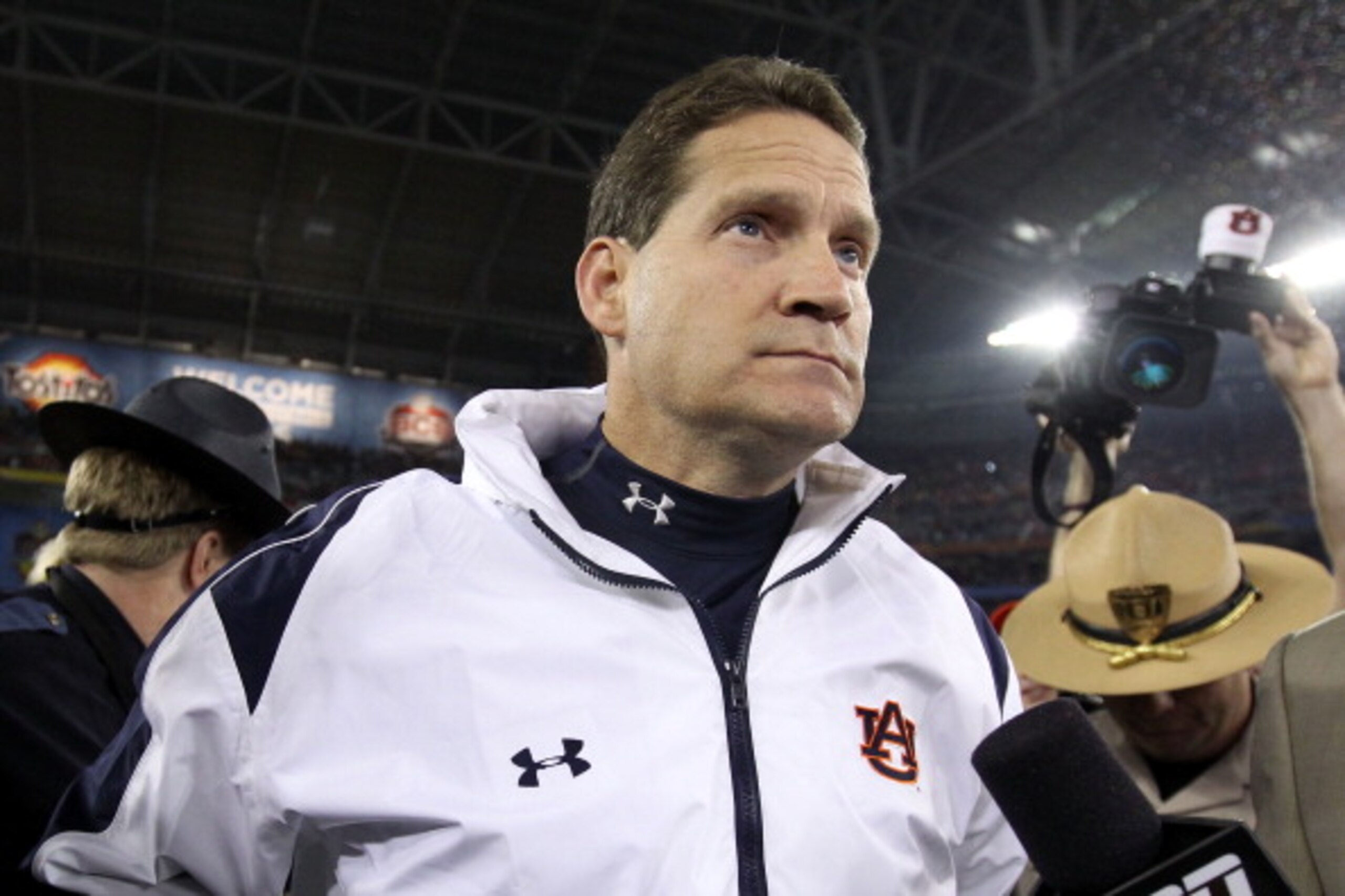 GLENDALE, AZ - JANUARY 10:  Head coach Gene Chizik of the Auburn Tigers celebrates the Tigers 22-19 victory against the Oregon Ducks during the Tostitos BCS National Championship Game at University of Phoenix Stadium on January 10, 2011 in Glendale, Arizo