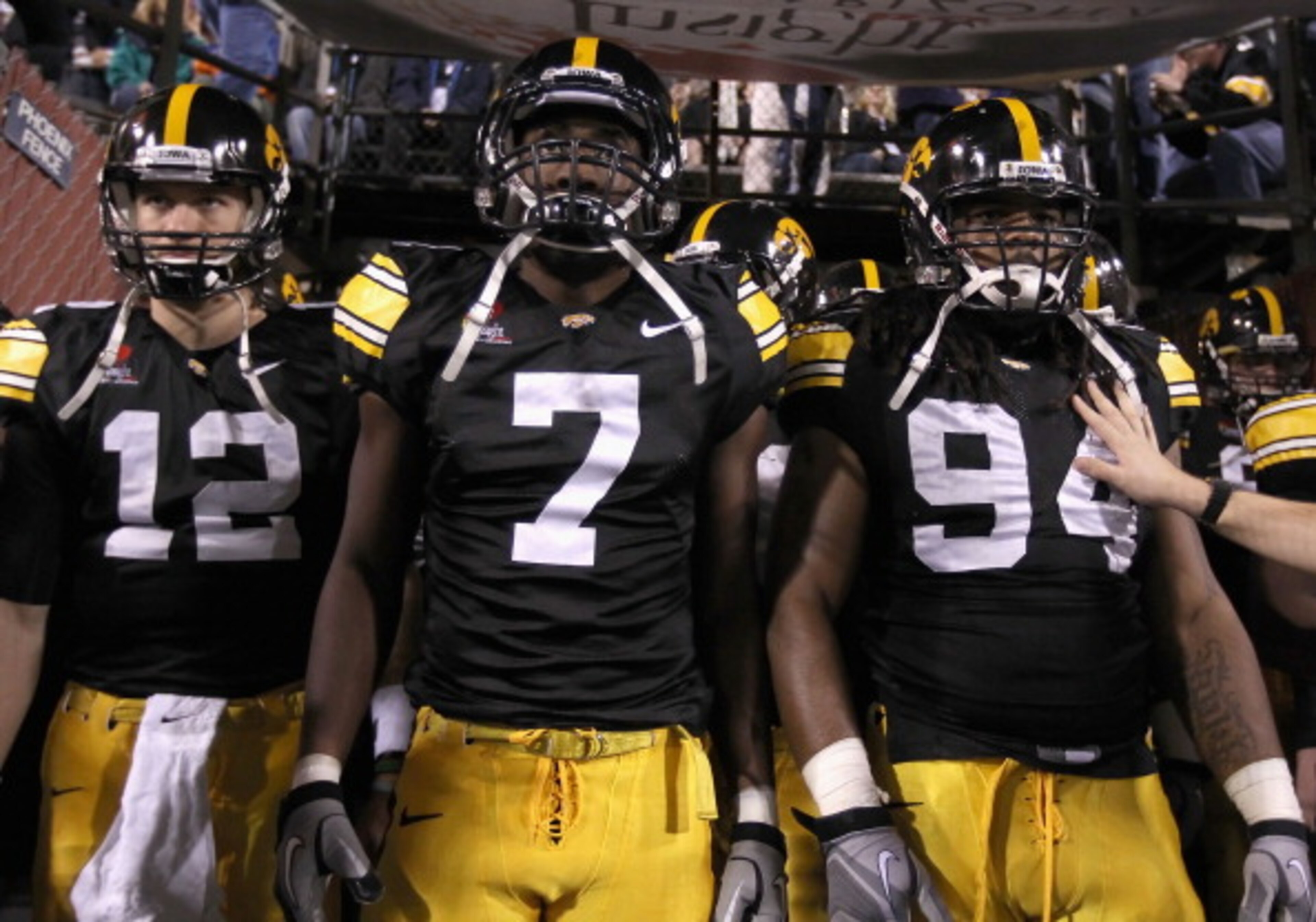 TEMPE, AZ - DECEMBER 28:  (L-R) Ricky Stanzi #12, Marvin McNutt #7 and Adrian Clayborn #94 of the Iowa Hawkeyes walk out onto the field for the Insight Bowl against the Missouri Tigers at Sun Devil Stadium on December 28, 2010 in Tempe, Arizona. The Hawke