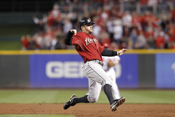 CINCINNATI, OH - SEPTEMBER 28: Jeff Keppinger #8 of the Houston Astros prepares to slide while trying to beat a throw to first against the Cincinnati Reds at Great American Ball Park on September 28, 2010 in Cincinnati, Ohio. The Reds won 3-2 to clinch th