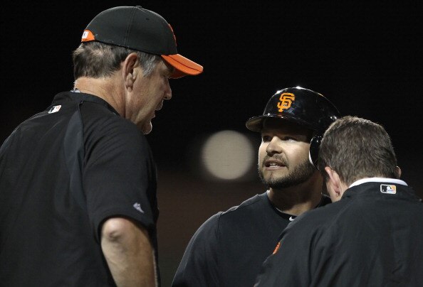 GLENDALE, AZ - MARCH 04:  Cody Ross #13 of the San Francisco Giants talks with manager Bruce Bochy  after Ross was hit by a pitch during the second inning of the spring training game against the Los Angeles Dodgers at Camelback Ranch on March 4, 2011 in G