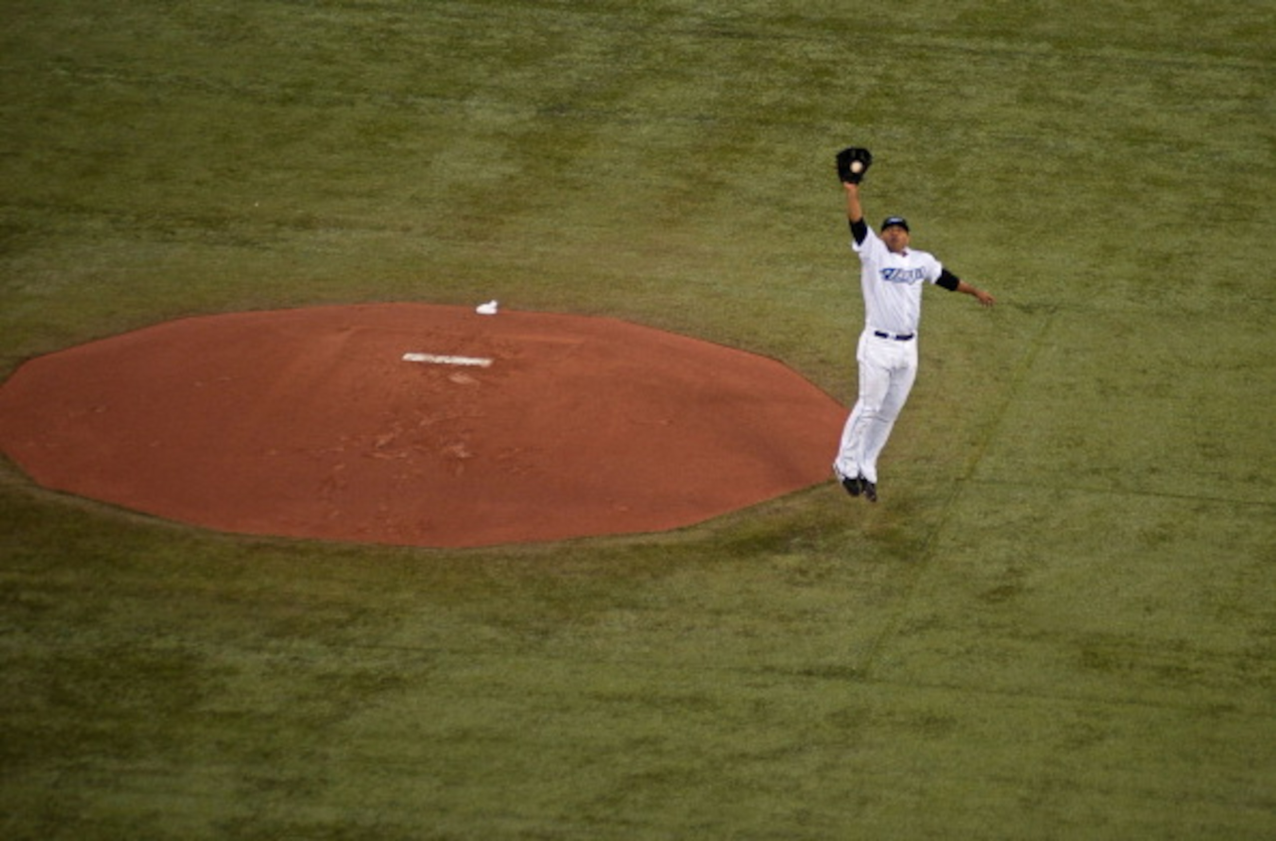 TORONTO,CANADA - APRIL 1:  Ricky Romero #24 jumps for a hit ball during the home opener for the Toronto Blue Jays as they face the Minnesota Twins during their MLB game at the Rogers Centre April 1, 2011 in Toronto, Ontario, Canada.(Photo By Dave Sandford