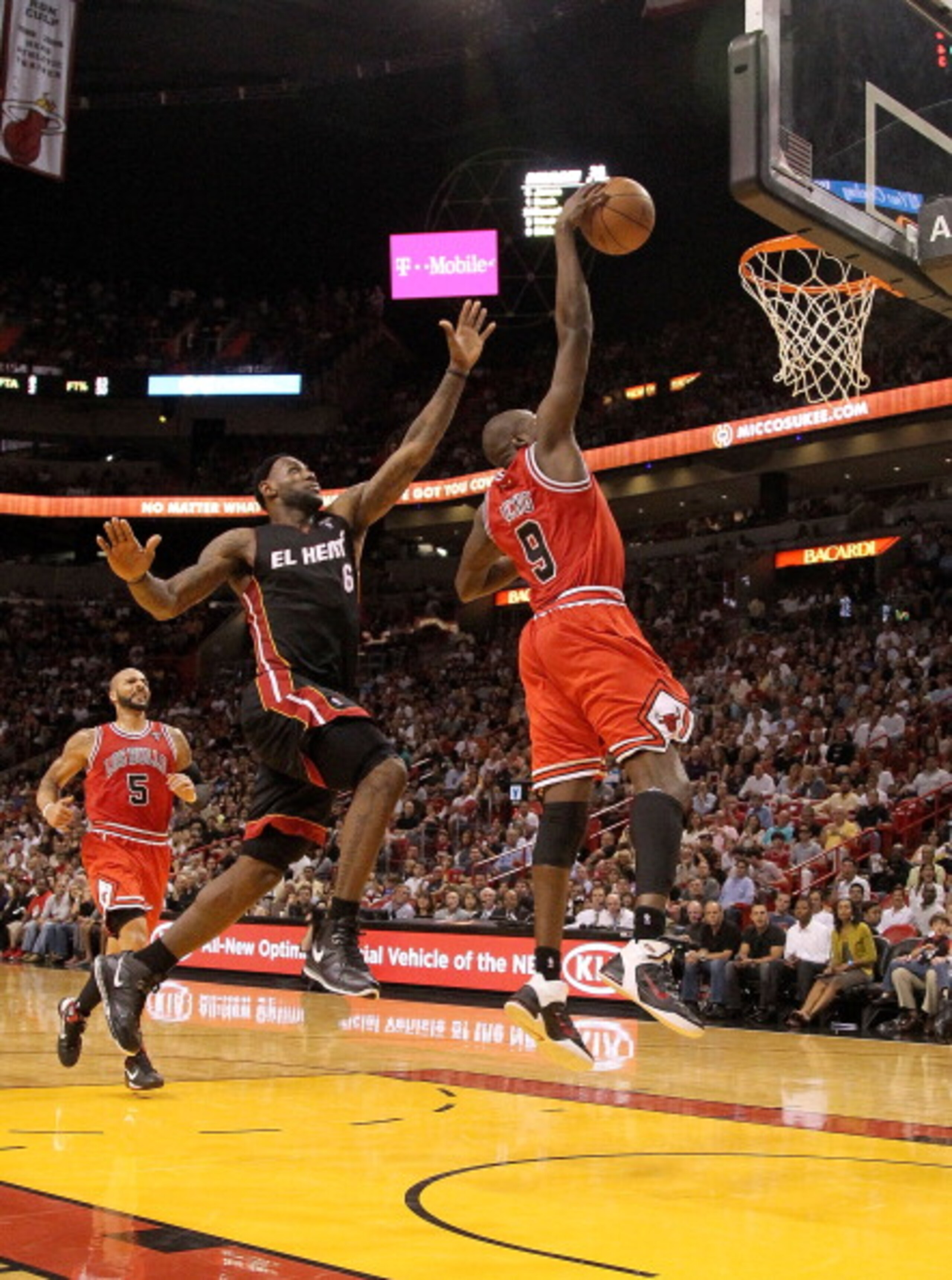 MIAMI, FL - MARCH 06:  Luol Deng #9 of the Chicago Bulls dunks past LeBron James #6 of the Miami Heat during a game at American Airlines Arena on March 6, 2011 in Miami, Florida. NOTE TO USER: User expressly acknowledges and agrees that, by downloading an