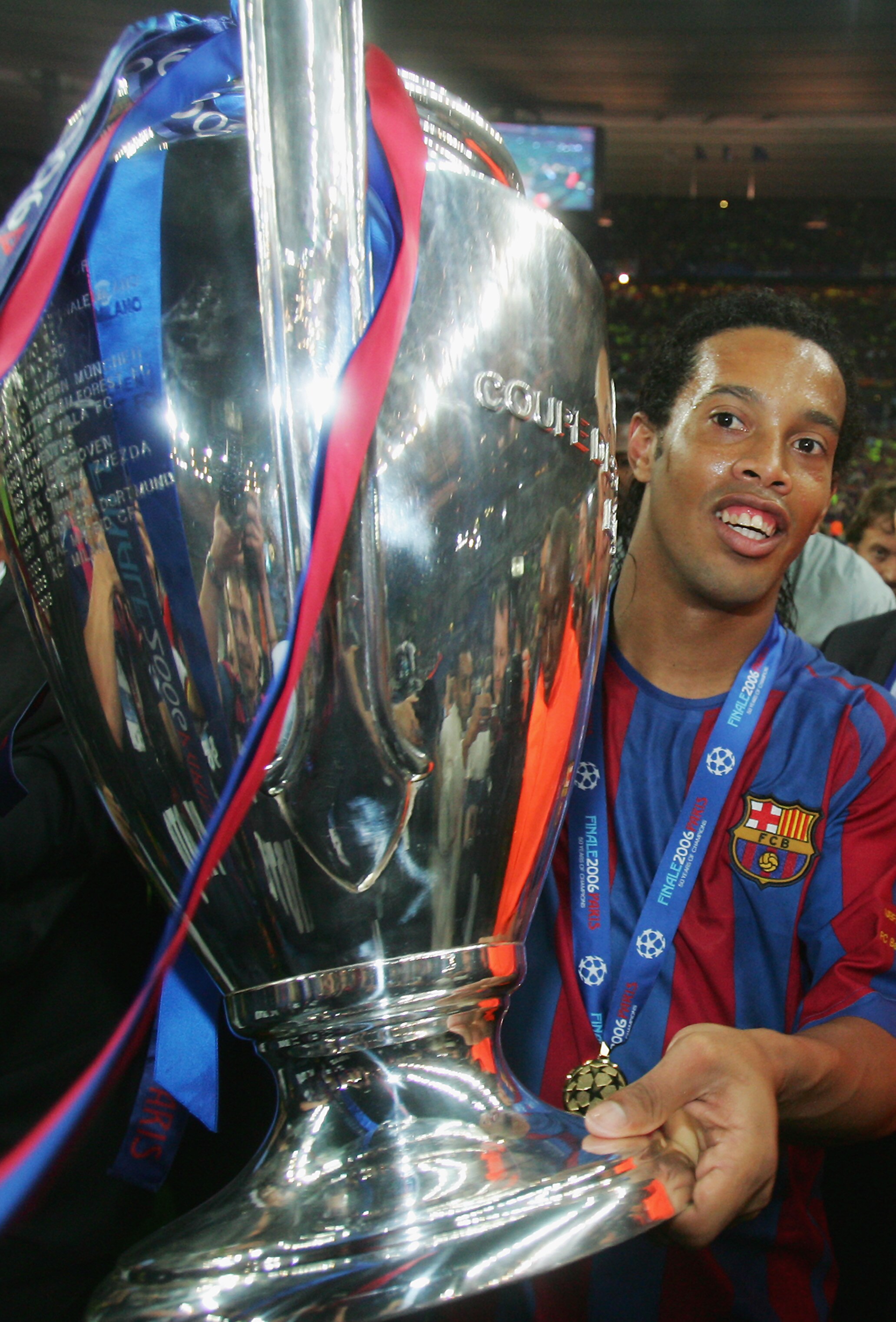 PARIS - MAY 17:  Ronaldinho of Barcelona celebrates with the trophy following the UEFA Champions League Final between Arsenal and Barcelona at the Stade de France on May 17, 2006 in Paris, France.  (Photo by Alex Livesey/Getty Images)