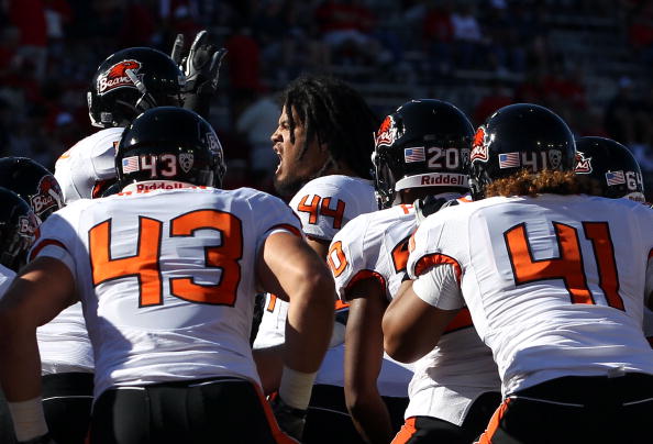TUCSON, AZ - OCTOBER 09:  Linebacker Uani Unga #44 (C) of the Oregon State Beavers pumps up his team in a huddle prior to the college football game against the Arizona Wildcats at Arizona Stadium on October 9, 2010 in Tucson, Arizona.  The Beavers defeate