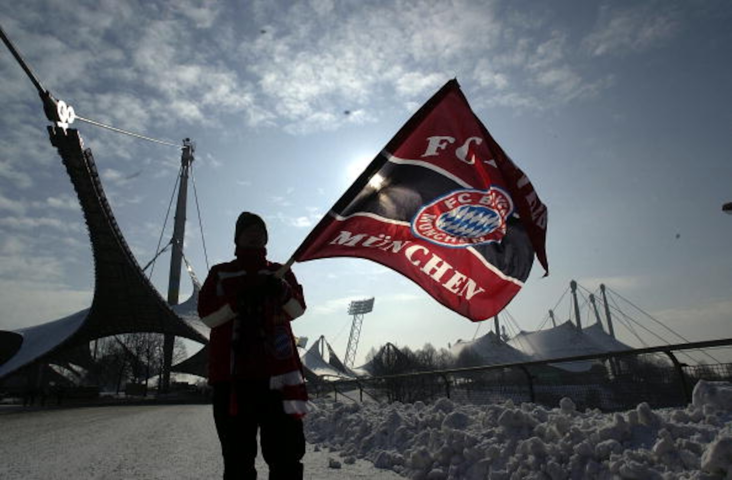 MUNICH - FEBRUARY 15:  A young  fan waves his Bayern Munich banner before the match at a snowy Olympic stadium before the Bundesliga match between 1860 Munich and FC Bayern Munich at The Olympic Stadium, Munich, Germany on febuary 15 2003. (Photo by Stuar