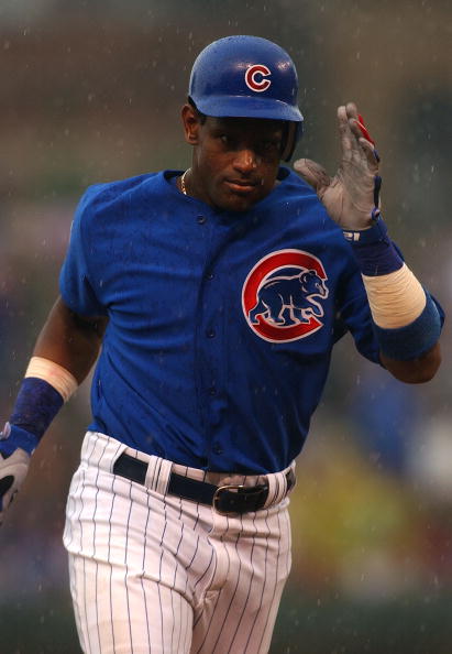 CHICAGO - JULY 21:  Sammy Sosa #21 of the Chicago Cubs runs the bases in the rain after hitting what proved to be the game-winning solo home run in the seventh inning against the Cincinnati Reds July 21, 2004 at Wrigley Field in Chicago, Illinois. The Cub