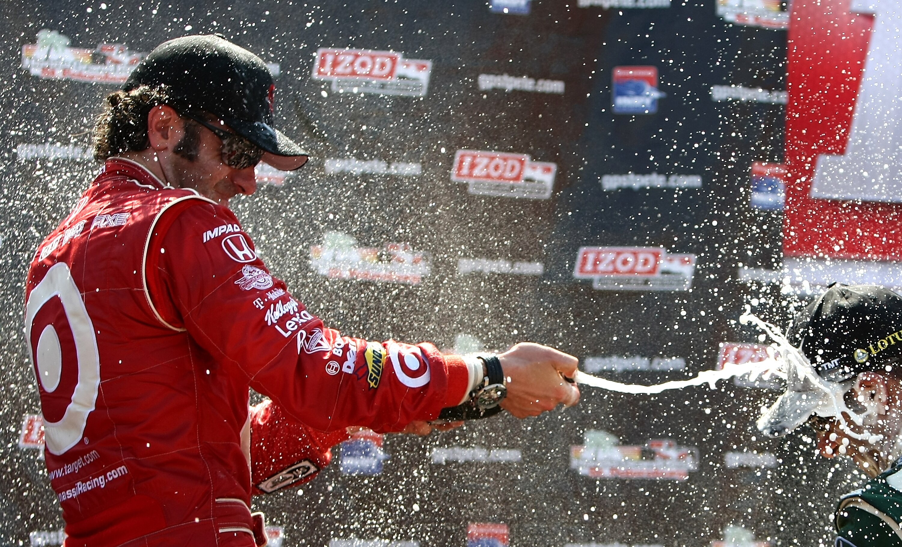 ST. PETERSBURG, FL - MARCH 27:  Race winner, Dario Franchitti, driver of the #10 target Chip Ganassi Racing Dallara Honda sprays 3rd place driver Tony Kanaan with champagne during the IndyCar Series Honda Grand Prix of St. Petersburg on March 27, 2011 in