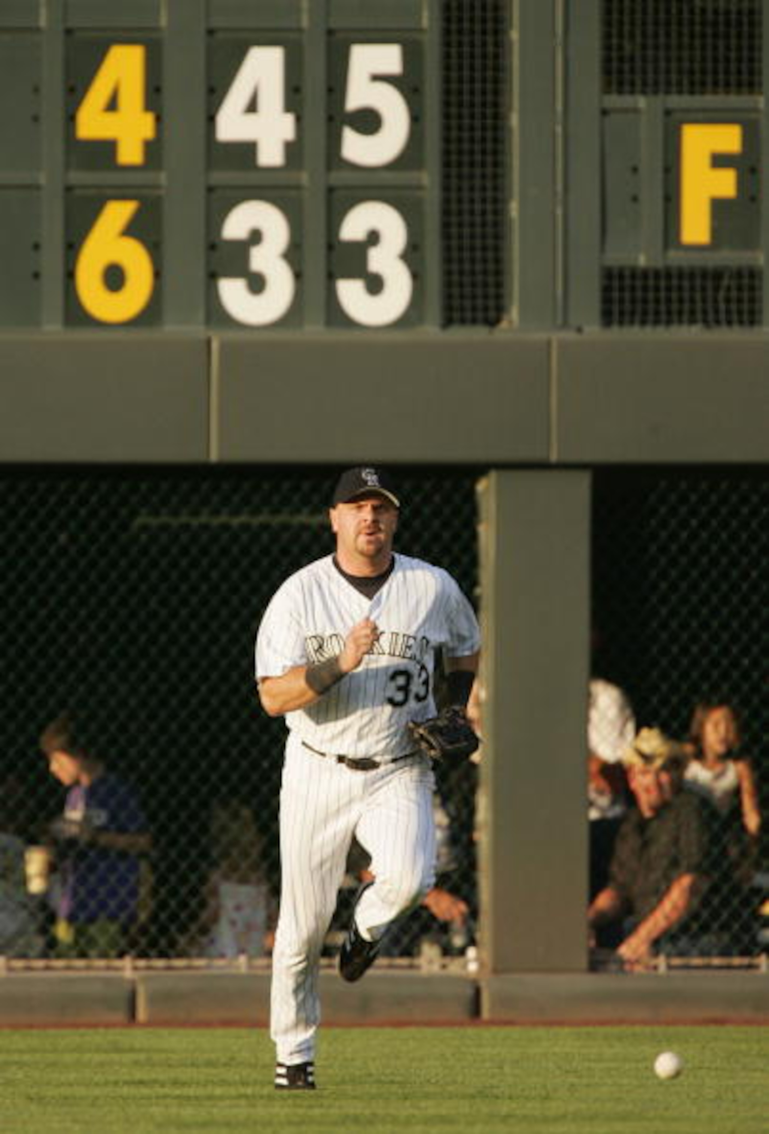 DENVER - JULY 31:  Larry Walker #33 of the Colorado Rockies chases down the ball as he plays it off the wall against the Arizona Diamondbacks in the fourth inning on July 31, 2004 at Coors Field in Denver, Colorado.  (Photo by Brian Bahr/Getty Images)