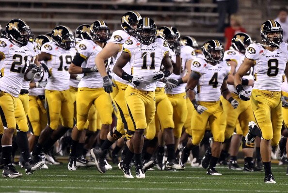 TEMPE, AZ - DECEMBER 28:  Jarrell Harrison #11 (C) of the Missouri Tigers runs onto the field with teammates before the Insight Bowl against the Iowa Hawkeyes at Sun Devil Stadium on December 28, 2010 in Tempe, Arizona.  (Photo by Christian Petersen/Getty