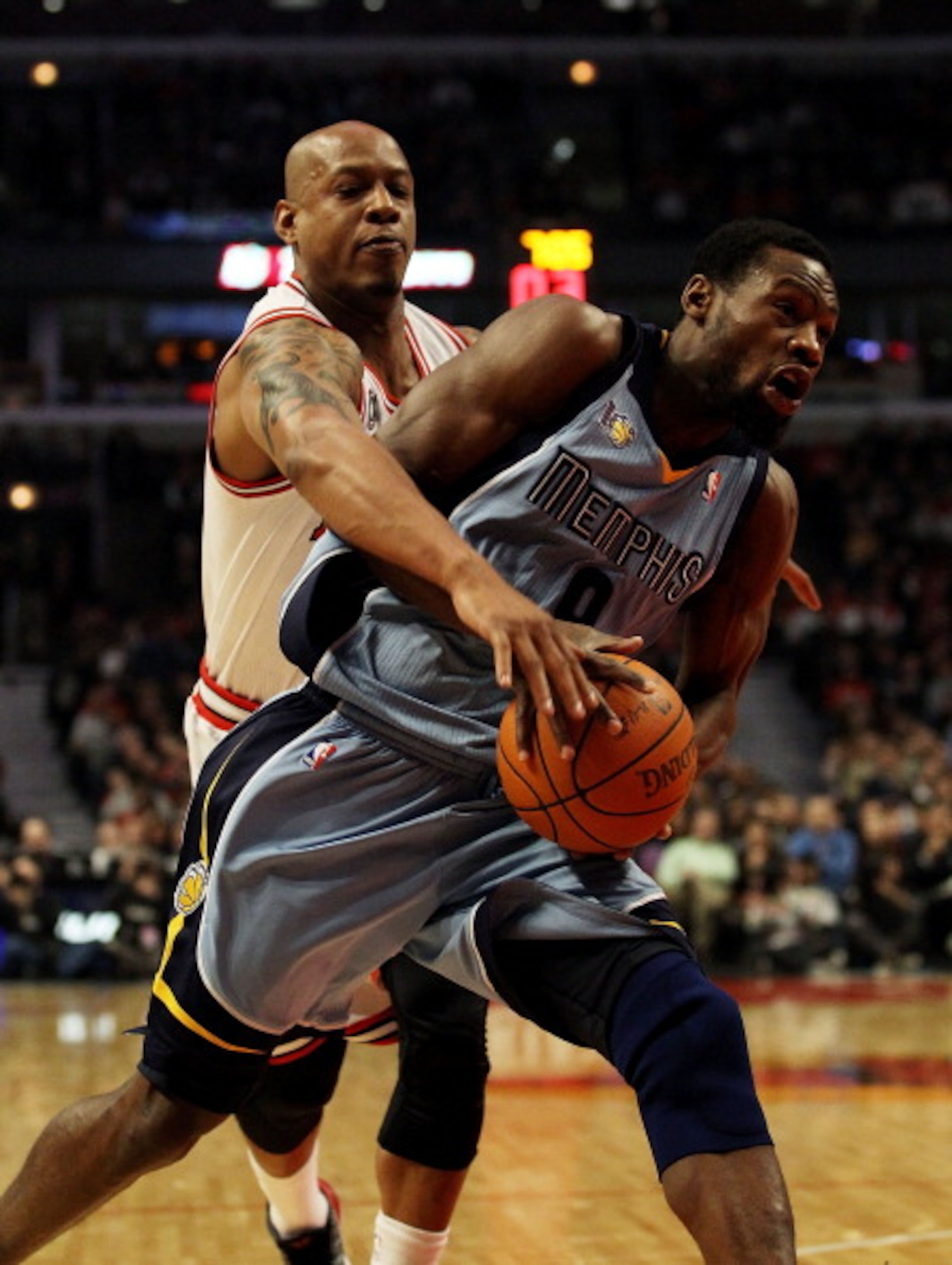 CHICAGO, IL - MARCH 25: Keith Bogans #6 of the Chicago Bulls reaches in and fouls Tony Allen #9 of the Memphis Girzzlies at the United Center on March 25, 2011 in Chicago, Illinois. NOTE TO USER: User expressly acknowledges and agrees that, by downloading