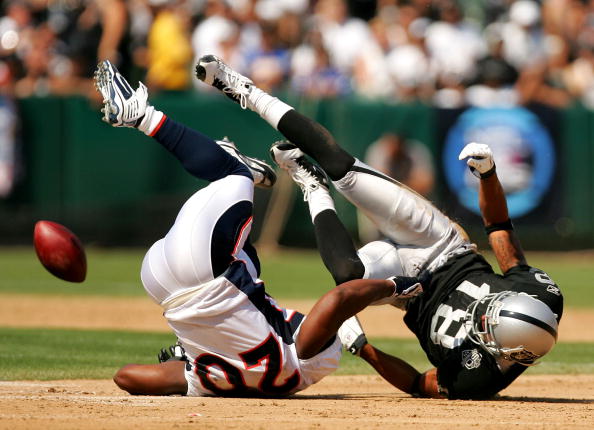 OAKLAND, CA - SEPTEMBER 27:  Louis Murphy #18 of the Oakland Raiders drops the ball after he is hit by Brian Dawkins #20 of the Denver Broncos at the Oakland-Alameda County Coliseum on September 27, 2009 in Oakland, California.  (Photo by Ezra Shaw/Getty