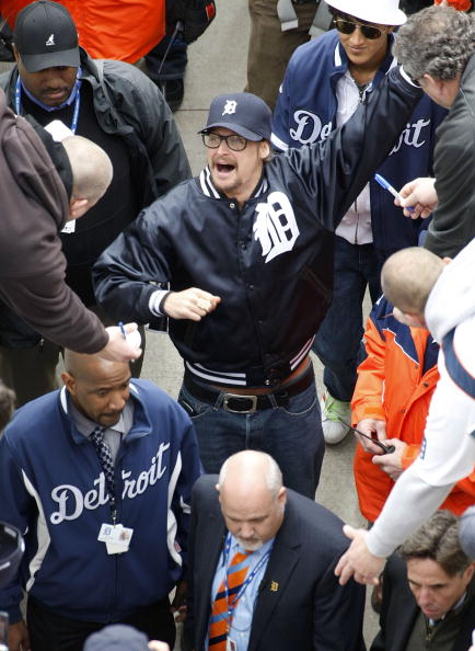 DETROIT - APRIL 10: Recording artist Kid Rock high fives fans while leaving the field after the pre game festivities prior to the Detroit Tigers playing the Texas Rangers during Opening Day on April 10, 2009 at Comerica Park in Detroit, Michigan.  (Photo