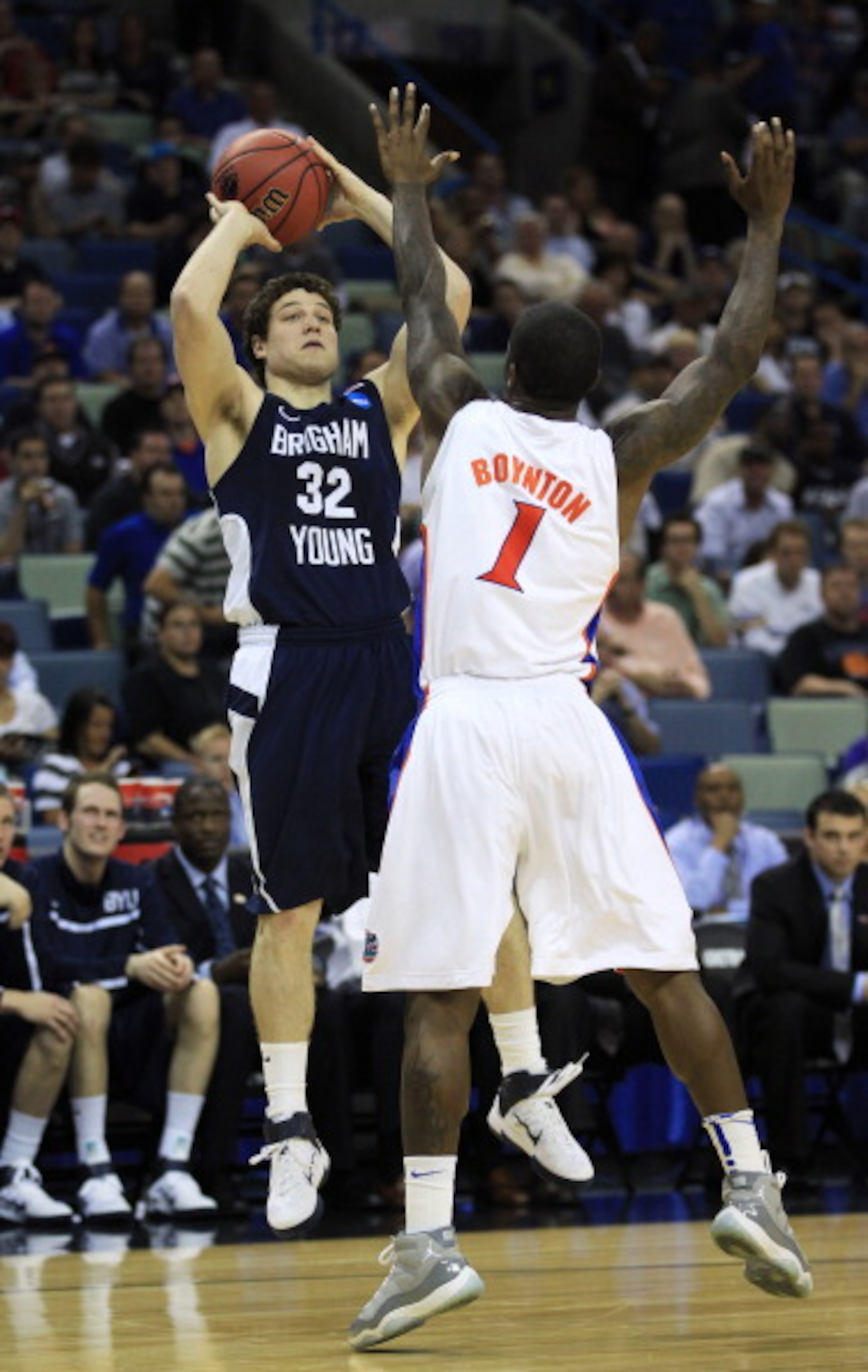 NEW ORLEANS, LA - MARCH 24:  Jimmer Fredette #32 of the Brigham Young Cougars shoots over Kenny Boynton #1 of the Florida Gators in the second half during the Southeast regional of the 2011 NCAA men's basketball tournament at New Orleans Arena on March 24