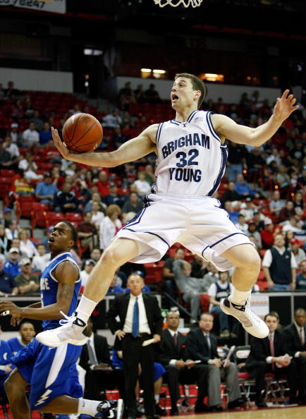 LAS VEGAS - MARCH 12:  Jimmer Fredette #32 of the Brigham Young University Cougars loses the ball after being fouled by Anwar Johnson #42 of the Air Force Falcons during a quarterfinal game of the Conoco Mountain West Conference Basketball Championships a