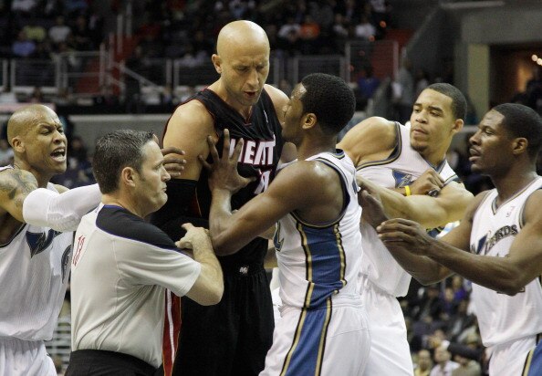 WASHINGTON, DC - MARCH 30: Zydrunas Ilgauskas #11 of the Miami Heat (C) and John Wall #2 of the Washington Wizards (R) are restrained by referee Monty McCutchen #13 (L) during the first half at the Verizon Center on March 30, 2011 in Washington, DC. Ilgau