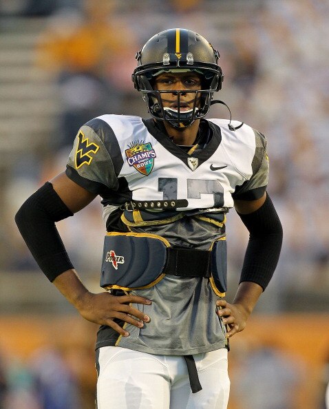 ORLANDO, FL - DECEMBER 28:  Geno Smith #12 of the West Virginia Mountineers warms up during the Champs Sports Bowl against the North Carolina State Wolfpack at Florida Citrus Bowl Stadium on December 28, 2010 in Orlando, Florida.  (Photo by Mike Ehrmann/G