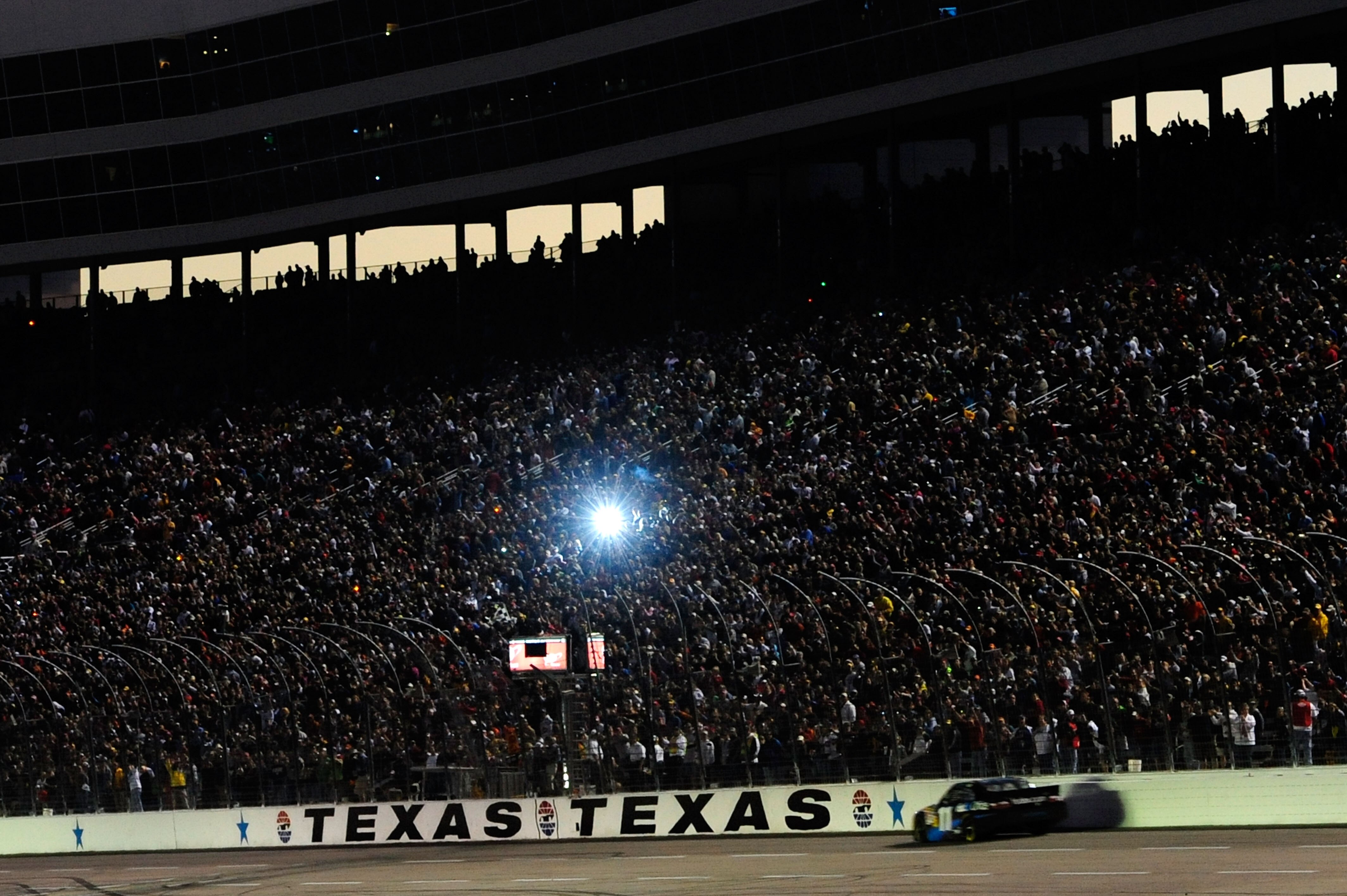 FORT WORTH, TX - NOVEMBER 07:  Denny Hamlin, driver of the #11 FedEx Office Toyota, comes to the finish line to win the NASCAR Sprint Cup Series AAA Texas 500 at Texas Motor Speedway on November 7, 2010 in Fort Worth, Texas.  (Photo by Robert Laberge/Gett