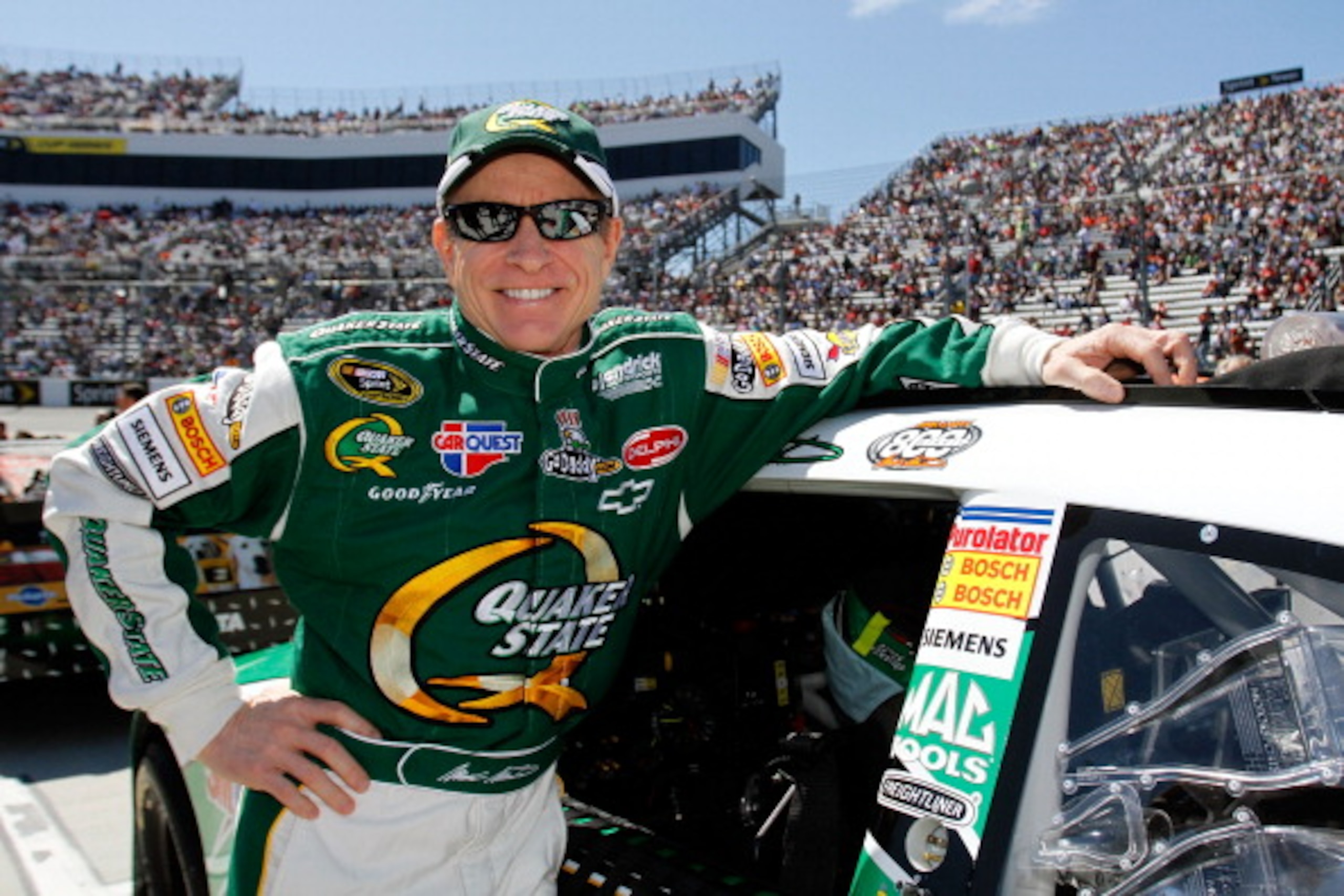 MARTINSVILLE, VA - APRIL 03: Mark Martin, driver of the #5 Quaker State/GoDaddy.com Chevrolet, stands next to his car on the grid prior to the NASCAR Sprint Cup Series Goody's Fast Relief 500 at Martinsville Speedway on April 3, 2011 in Martinsville, Vir MARTINSVILLE, VA - APRIL 03: Mark Martin, driver of the #5 Quaker State/GoDaddy.com Chevrolet, stands next to his car on the grid prior to the NASCAR Sprint Cup Series Goody's Fast Relief 500 at Martinsville Speedway on April 3, 2011 in Martinsville, Vir