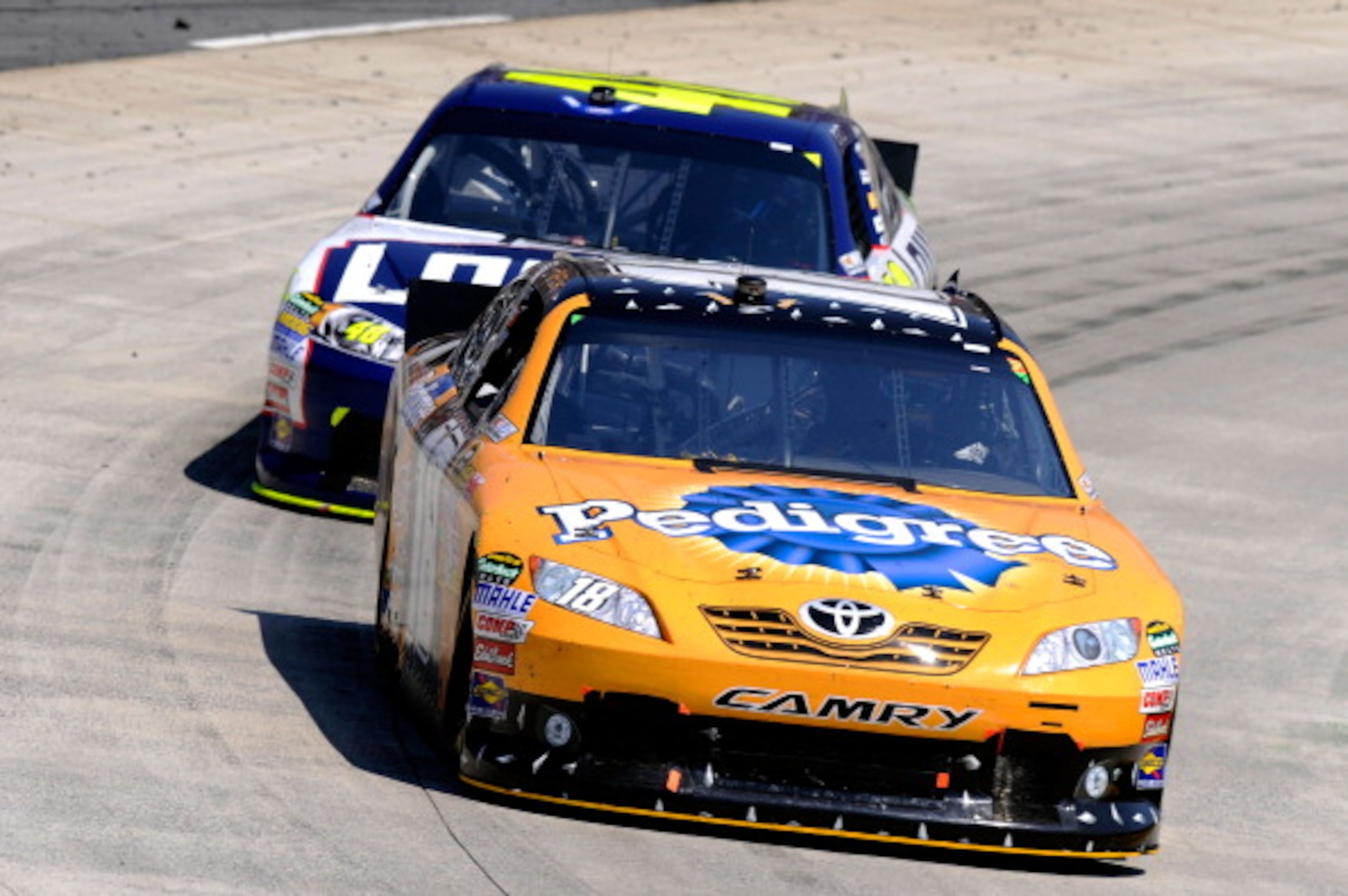 MARTINSVILLE, VA - APRIL 03: Kyle Busch, driver of the #18 Pedigree Toyota, leads Jimmie Johnson, driver of the #48 Lowe's Chevrolet, during the NASCAR Sprint Cup Series Goody's Fast Relief 500 at Martinsville Speedway on April 3, 2011 in Martinsville, V MARTINSVILLE, VA - APRIL 03: Kyle Busch, driver of the #18 Pedigree Toyota, leads Jimmie Johnson, driver of the #48 Lowe's Chevrolet, during the NASCAR Sprint Cup Series Goody's Fast Relief 500 at Martinsville Speedway on April 3, 2011 in Martinsville, V