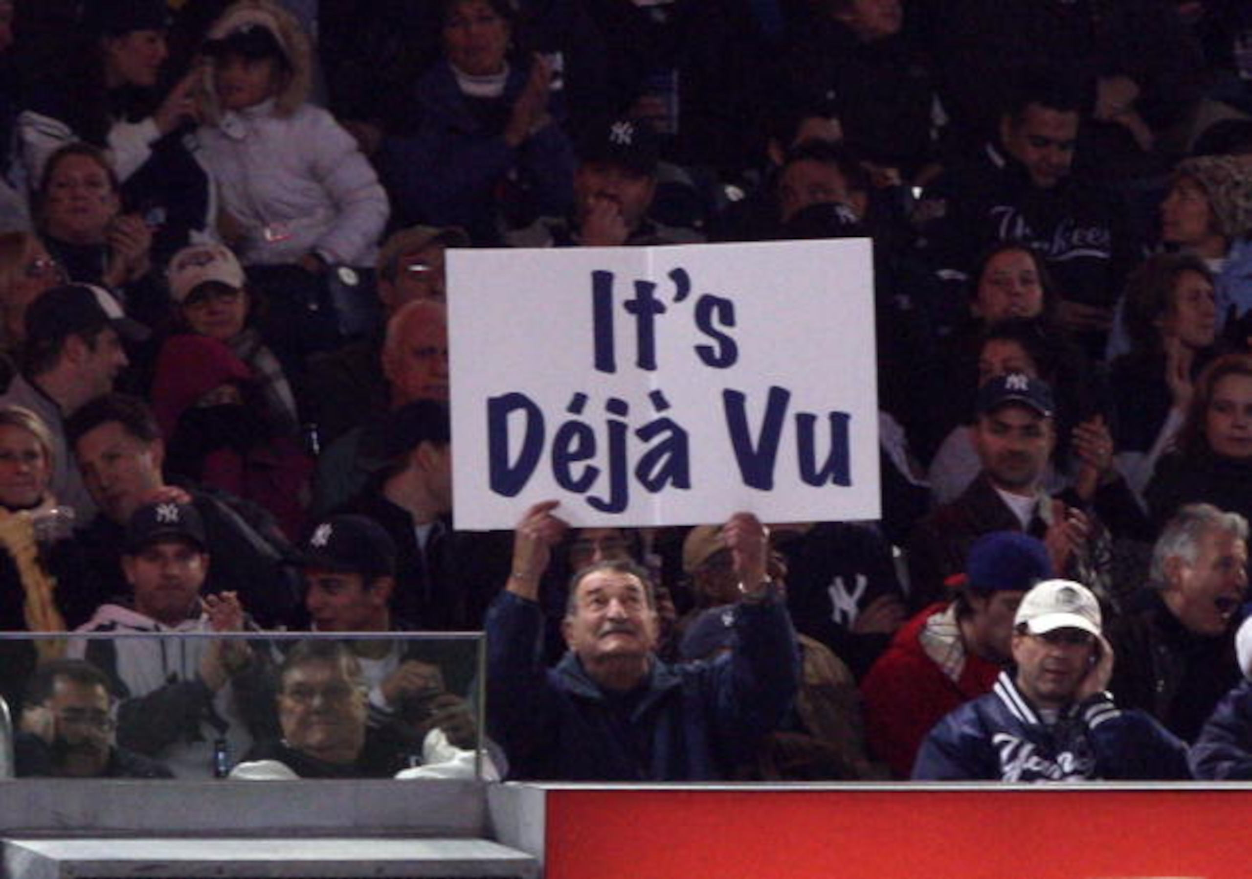 NEW YORK - OCTOBER 29: A fan of the New York Yankees holds up a sign which reads 'It's Deja Vu' in reference to Hall of Famer Yogi Berra against the Philadelphia Phillies in Game Two of the 2009 MLB World Series at Yankee Stadium on October 29, 2009 in t NEW YORK - OCTOBER 29: A fan of the New York Yankees holds up a sign which reads 'It's Deja Vu' in reference to Hall of Famer Yogi Berra against the Philadelphia Phillies in Game Two of the 2009 MLB World Series at Yankee Stadium on October 29, 2009 in t