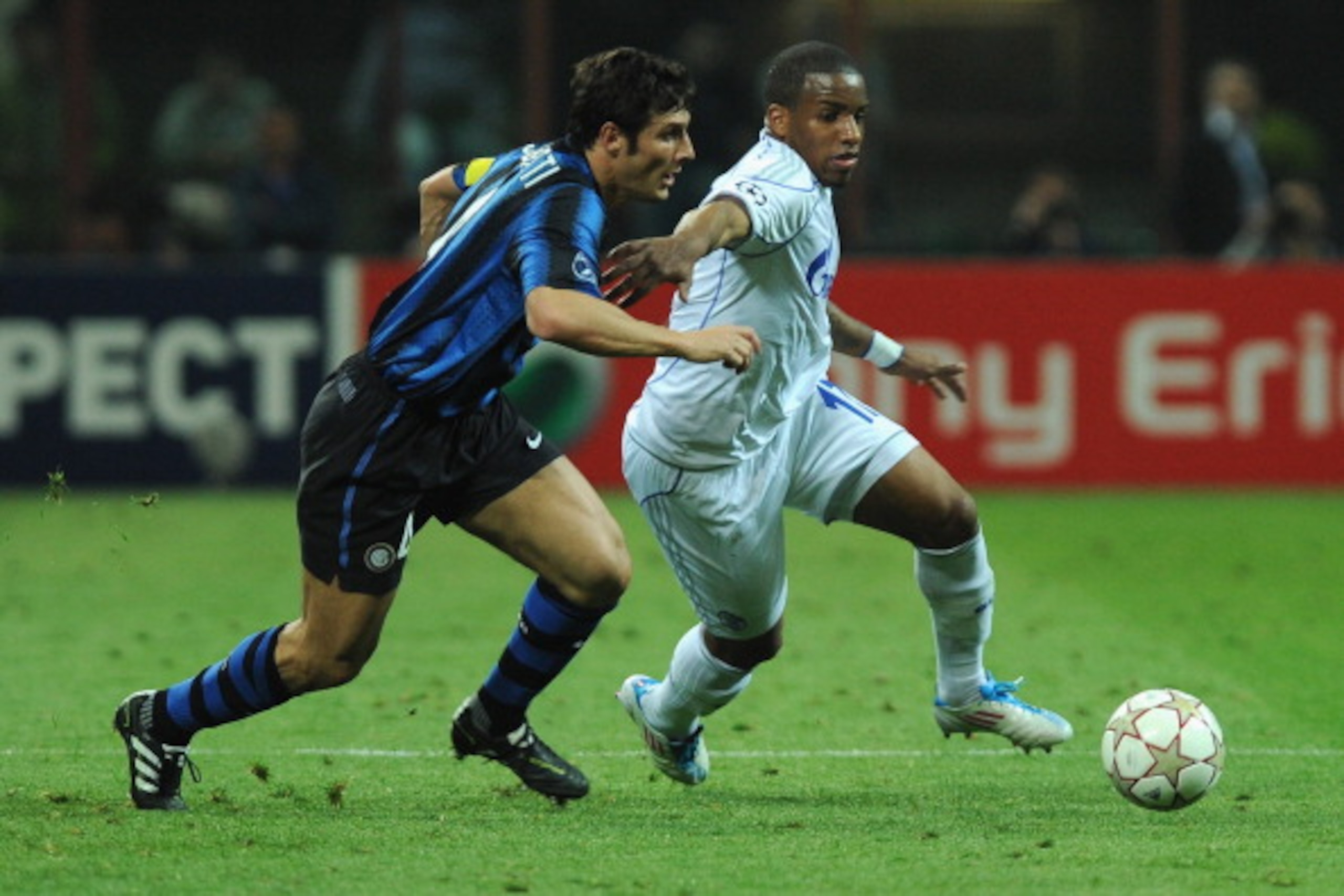 MILAN, ITALY - APRIL 05:  Javier Zanetti of FC Internazionale Milano  battles for the ball with Jefferson Farfan of Schalke 04 during the UEFA Champions League Quarter Final match between FC Internazionale Milano and Schalke 04 at San Siro Stadium on Apri