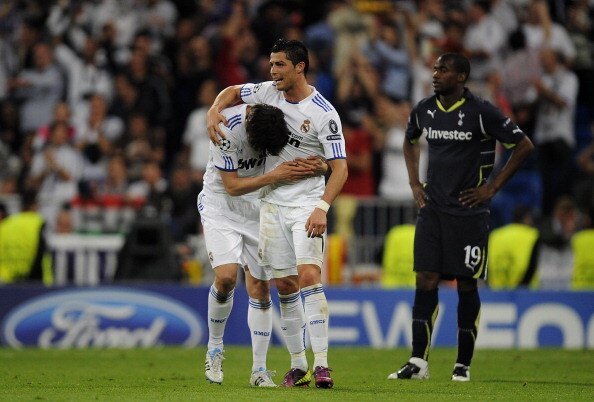 MADRID, SPAIN - APRIL 05:  Sebastien Bassong of Tottenham Hotspur (L) looks dejected as Cristiano Ronaldo(C)  celebrates his team's fourth goal with team mate Kaka during the UEFA Champions League quarter final first leg match between Real Madrid and Tott