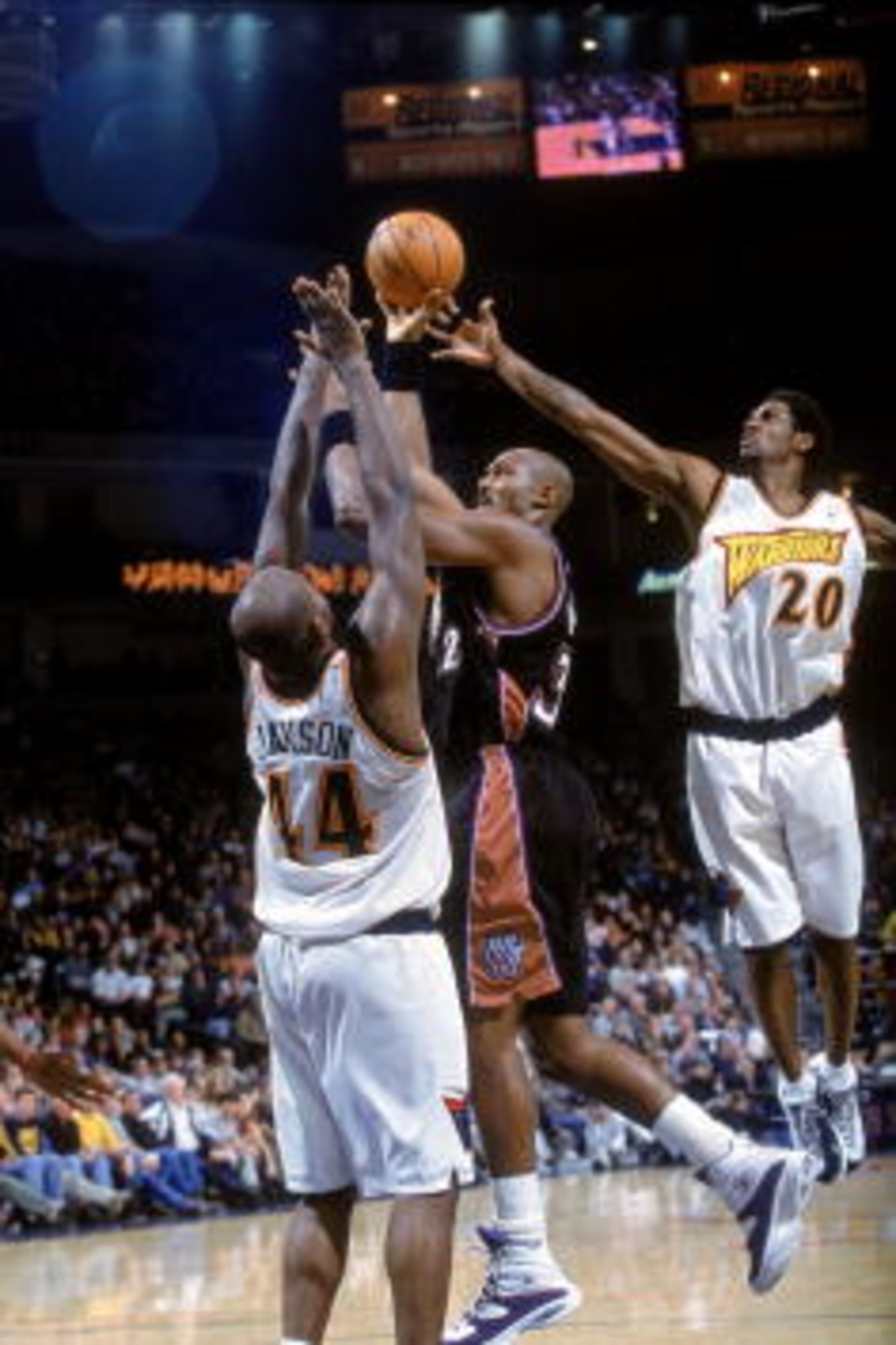 29 Dec 2000:  Karl Malone #32 of the Utah Jazz leaps for the basket as he is double teammed by Larry Hughes #20 and Marc Jackson #44 of the Golden State Warriors at The Arena of Oakland in California.  The Warriors defeated the Jazz 100-89.    NOTE TO USE