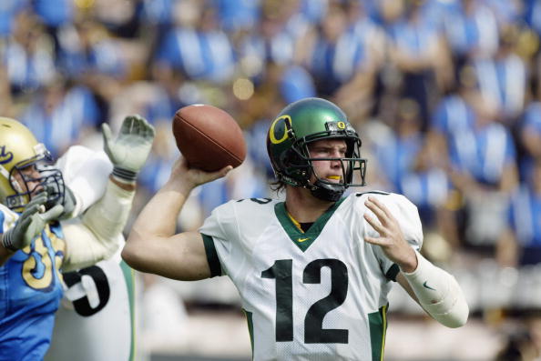 PASADENA, CA - OCTOBER 12:  Quarterback Jason Fife #12 of the Oregon Ducks throws the ball under pressure during the NCAA football game against the UCLA Bruins at the Rose Bowl on October 12, 2002 in Pasadena, California.  Oregon defeated UCLA 31-30.  (Ph