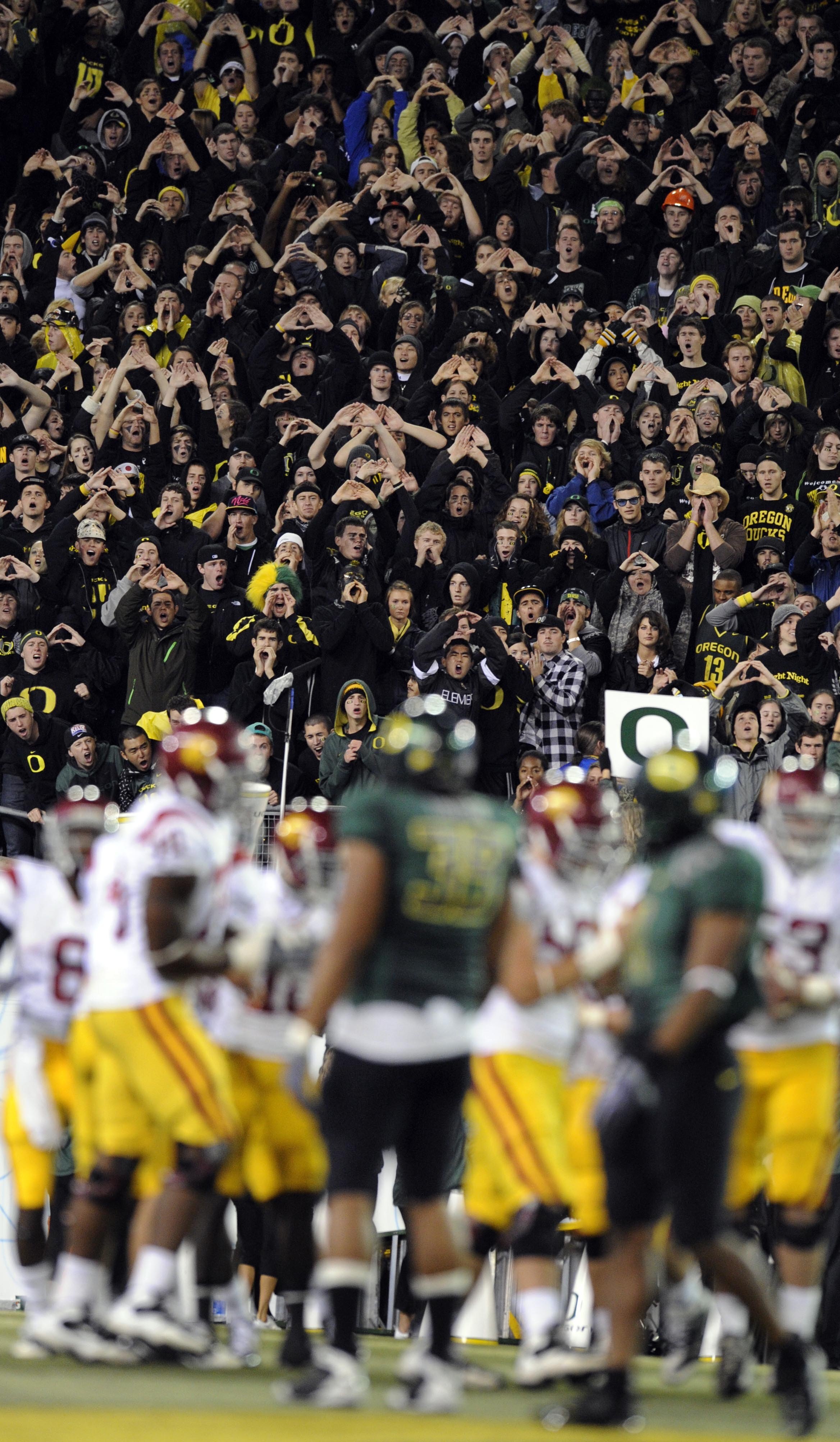 EUGENE, OR - OCTOBER 31:  Oregon Ducks fans make some noise on a Halloween night game against the USC Trojans at Autzen Stadium on October 31, 2009 in Eugene, Oregon. The crowd noise at Autzen Stadium is said to be one of the loudest in the nation and rep