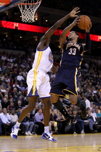 OAKLAND, CA - JANUARY 19:  Danny Granger #33 of the Indiana Pacers goes up for a shot on Ekpe Udoh #20 of the Golden State Warriors at Oracle Arena on January 19, 2011 in Oakland, California.  NOTE TO USER: User expressly acknowledges and agrees that, by 
