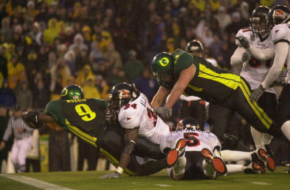 EUGENE, OR - DECEMBER 1:  Tailback Maurice Morris #9 of Oregon Ducks dives for the goalline against linebacker James Allen #34 of the Oregon State Beavers at Autzen Stadium in Eugene Oregon on December 1, 2001.  Oregon defeated Oregon State 17-14.  (Photo