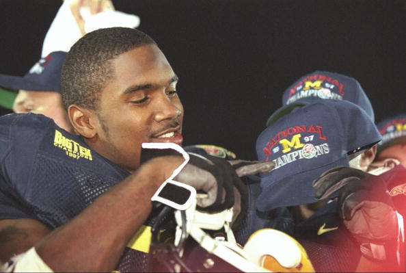 Charles Woodson #2 of Michigan points to his National Champions cap after the Wolverines 21-16 win over Washington State in the 1998 Rose Bowl at the Rose Bowl in Pasadena, California.