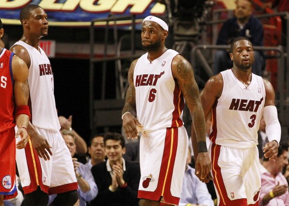 MIAMI, FL - MARCH 25:  Forward Chris Bosh #1, Forward LeBron James #6 and Guard Dwyane Wade #3 of the Miami Heat against the Philadelphia Sixers at American Airlines Arena on March 25, 2011 in Miami, Florida. The Heat defeated the Sixers 111-99. NOTE TO U