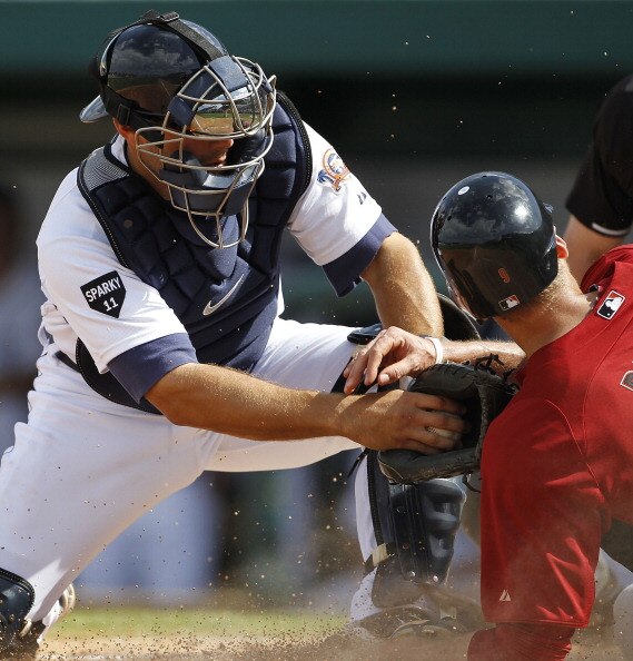 LAKELAND, FL - MARCH 02: Alex Avila #13 of the Detroit Tigers tags out Hunter Pence #9 of the Houston Astros during the game at Joker Marchant Stadium on March 2, 2011 in Lakeland, Florida. The Astros defeated the Tigers 6-3.  (Photo by Leon Halip/Getty I