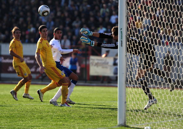 BOTOSANI, ROMANIA - OCTOBER 12:  Christpher Smalling of England U21 is foiled by Silviu Lung of Romania U21 during the UEFA Euro 2011 U21 Championship play-off, second leg match between Romania U21 and England U21 at the Municipal Stadium Botosani on Octo