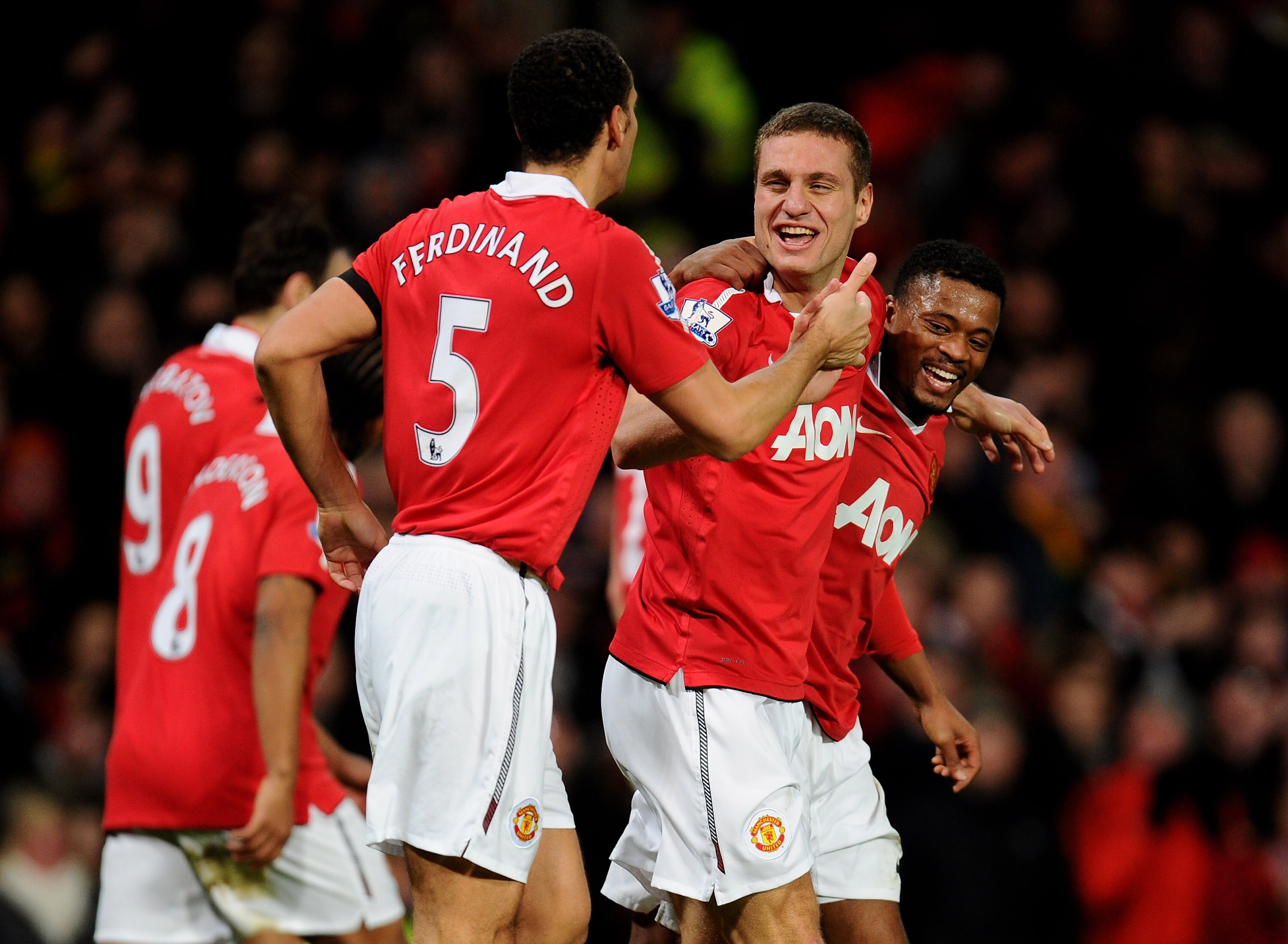 MANCHESTER, ENGLAND - FEBRUARY 01:  Nemanja Vidic of Manchester United celebrates scoring his team's third goal with team mates Rio Ferdinand and Patrice Evra (R) during the Barclays Premier League match between Manchester United and Aston Villa at Old Tr