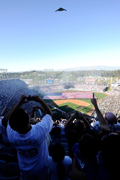 LOS ANGELES, CA - MARCH 31:  Fans watch as a B-2 bomber perfoms a fly-over prior to the Los Angeles Dodgers playing the San Francisco Giants on Opening Day at Dodger Stadium on March 31, 2011 in Los Angeles, California.  (Photo by Kevork Djansezian/Getty