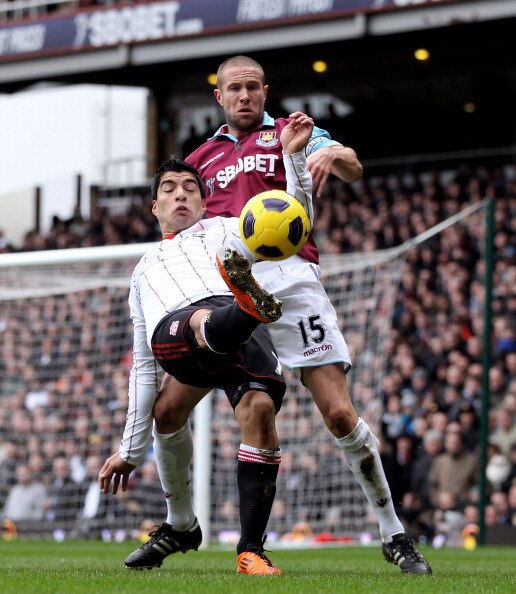 LONDON, ENGLAND - FEBRUARY 27:  Luis Suarez of Liverpool (front) tangles with Matthew Upson of West Ham during the Barclays Premier League match between West Ham United and Liverpool at the Boleyn Ground on February 27, 2011 in London, England.  (Photo by