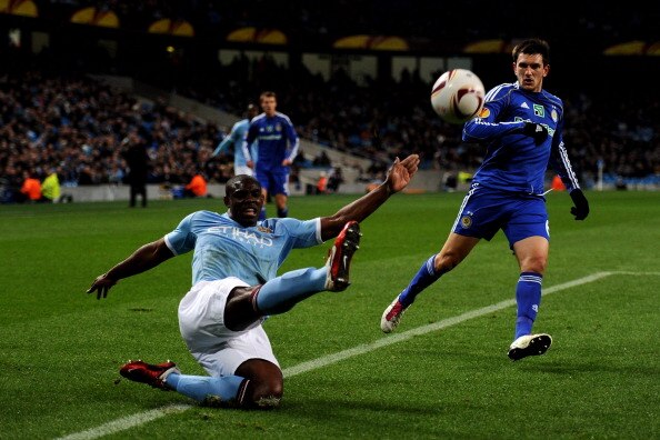 MANCHESTER, ENGLAND - MARCH 17: Micah Richards of Manchester City beats Goran Popov of Dynamo Kiev to the ball during the UEFA Europa League round of 16 second leg match between Manchester City and Dynamo Kiev at City of Manchester Stadium on March 17, 20