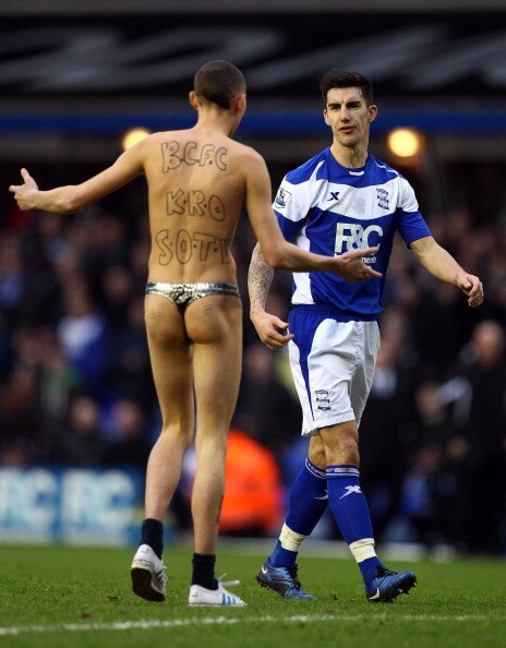 BIRMINGHAM, ENGLAND - JANUARY 16:  Liam Ridgewell of Birmingham tells a streaker to leave the pitch during the Barclays Premier League match between Birmingham City and Aston Villa at St.Andrews on January 16, 2011 in Birmingham, England.  (Photo by Richa