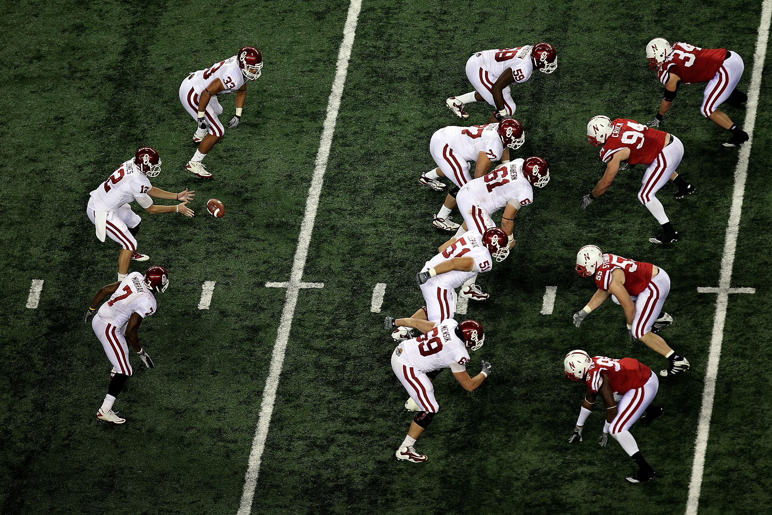 ARLINGTON, TX - DECEMBER 04:  Quarterback Landry Jones #12 of the Oklahoma Sooners takes the snap against the Nebraska Cornhuskers during the Big 12 Championship at Cowboys Stadium on December 4, 2010 in Arlington, Texas.  (Photo by Ronald Martinez/Getty