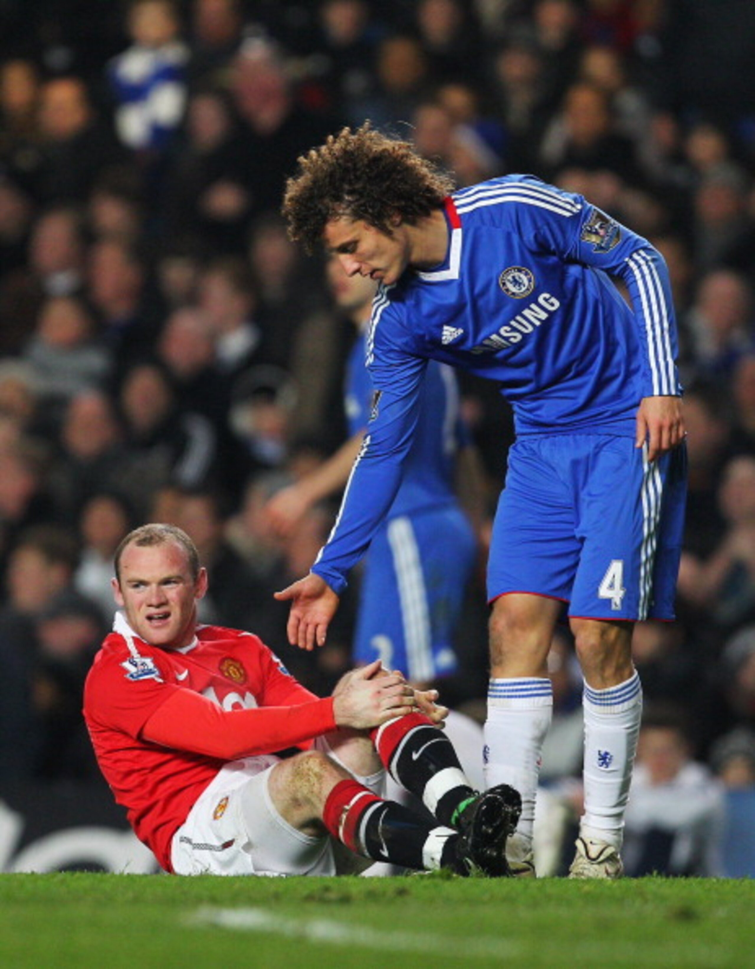 LONDON, ENGLAND - MARCH 01:  David Luiz of Chelsea offers his hand to Wayne Rooney of Manchester United during the Barclays Premier League match between Chelsea and Manchester United at Stamford Bridge on March 1, 2011 in London, England.  (Photo by Clive
