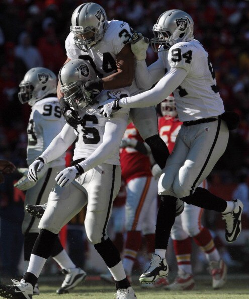 KANSAS CITY, MO - JANUARY 02: Oakland Raiders defensive players celebrate after stopping the Kansas City Chiefs during the game on January 2, 2011 at Arrowhead Stadium in Kansas City, Missouri.  (Photo by Jamie Squire/Getty Images)